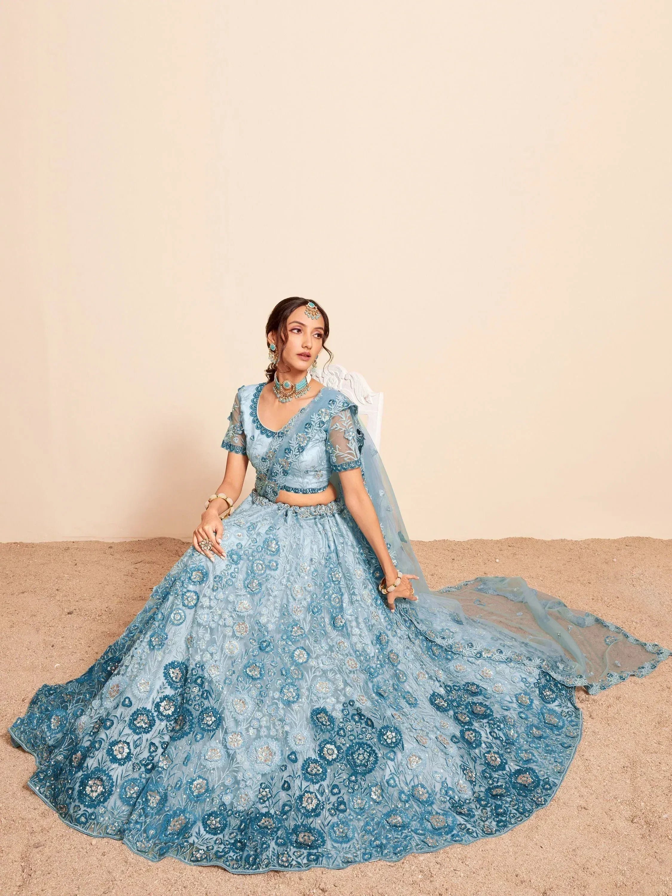 Blue floral embroidered lehenga choli with sheer dupatta, perfect for Indian weddings and festive occasions.