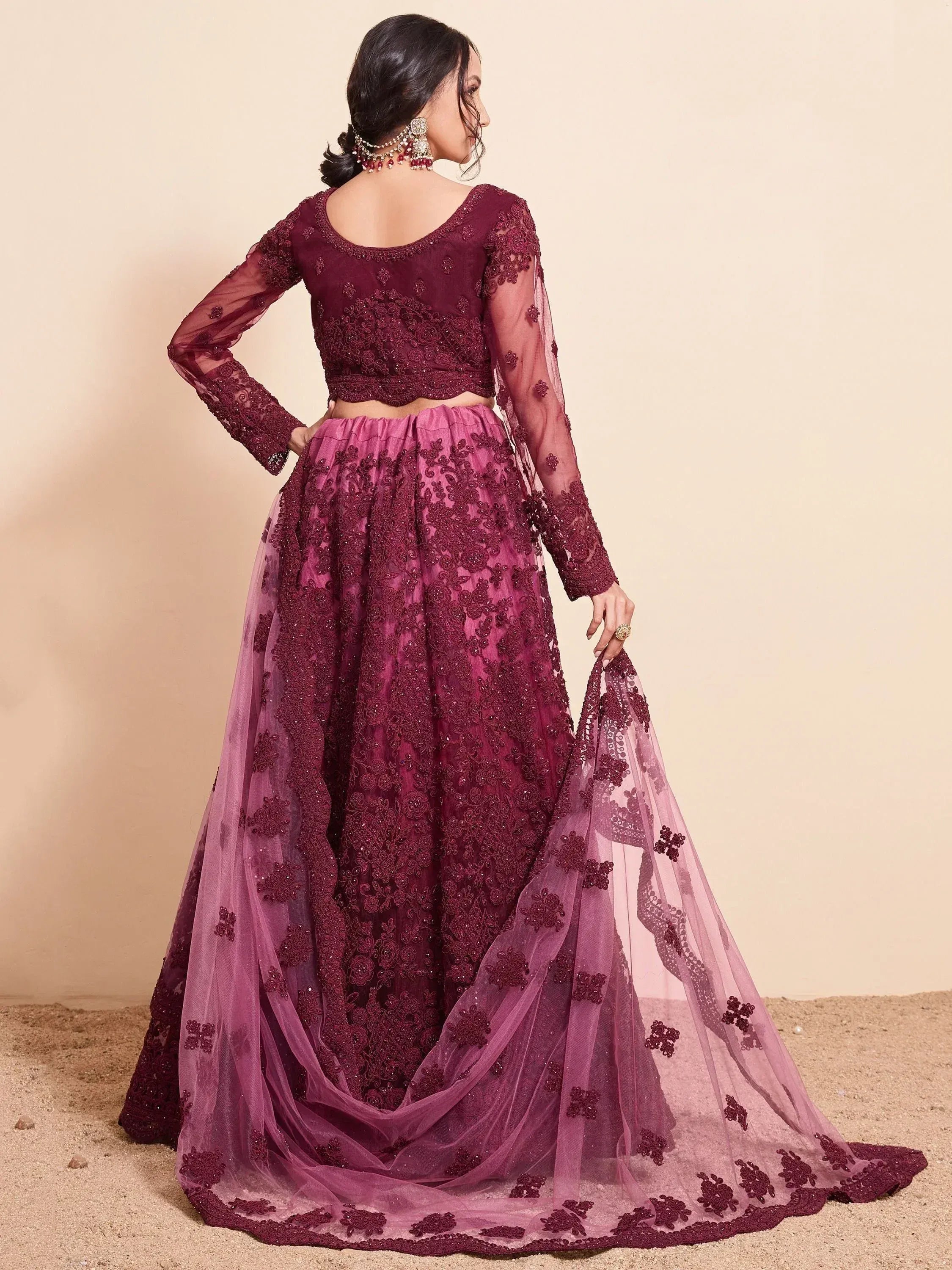 Burgundy embroidered lehenga choli with sheer sleeves and floral detailing, perfect for Indian ethnic wear occasions.