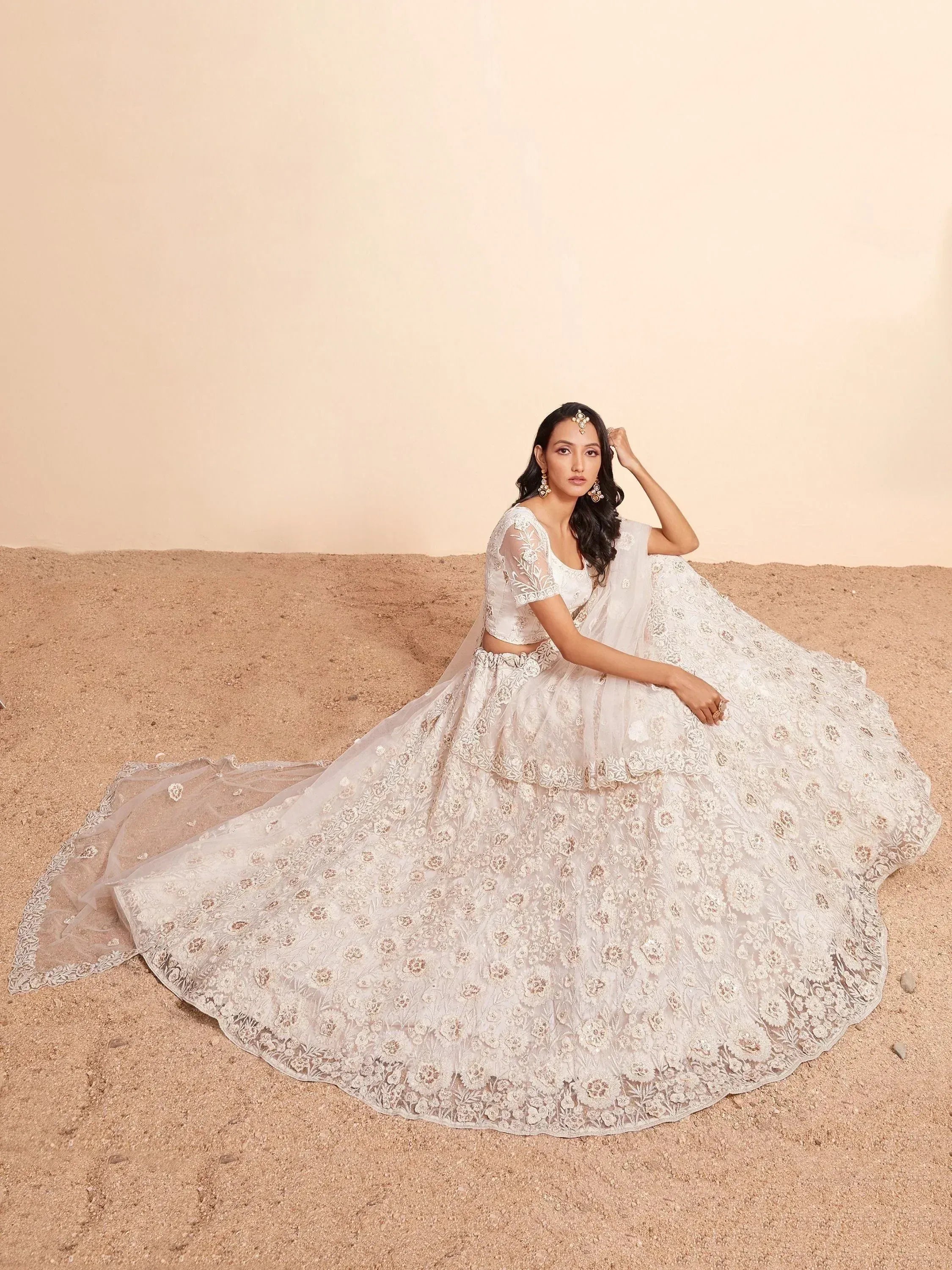 Elegant white floral embroidered lehenga choli with sheer dupatta, perfect for Indian weddings and festive occasions.