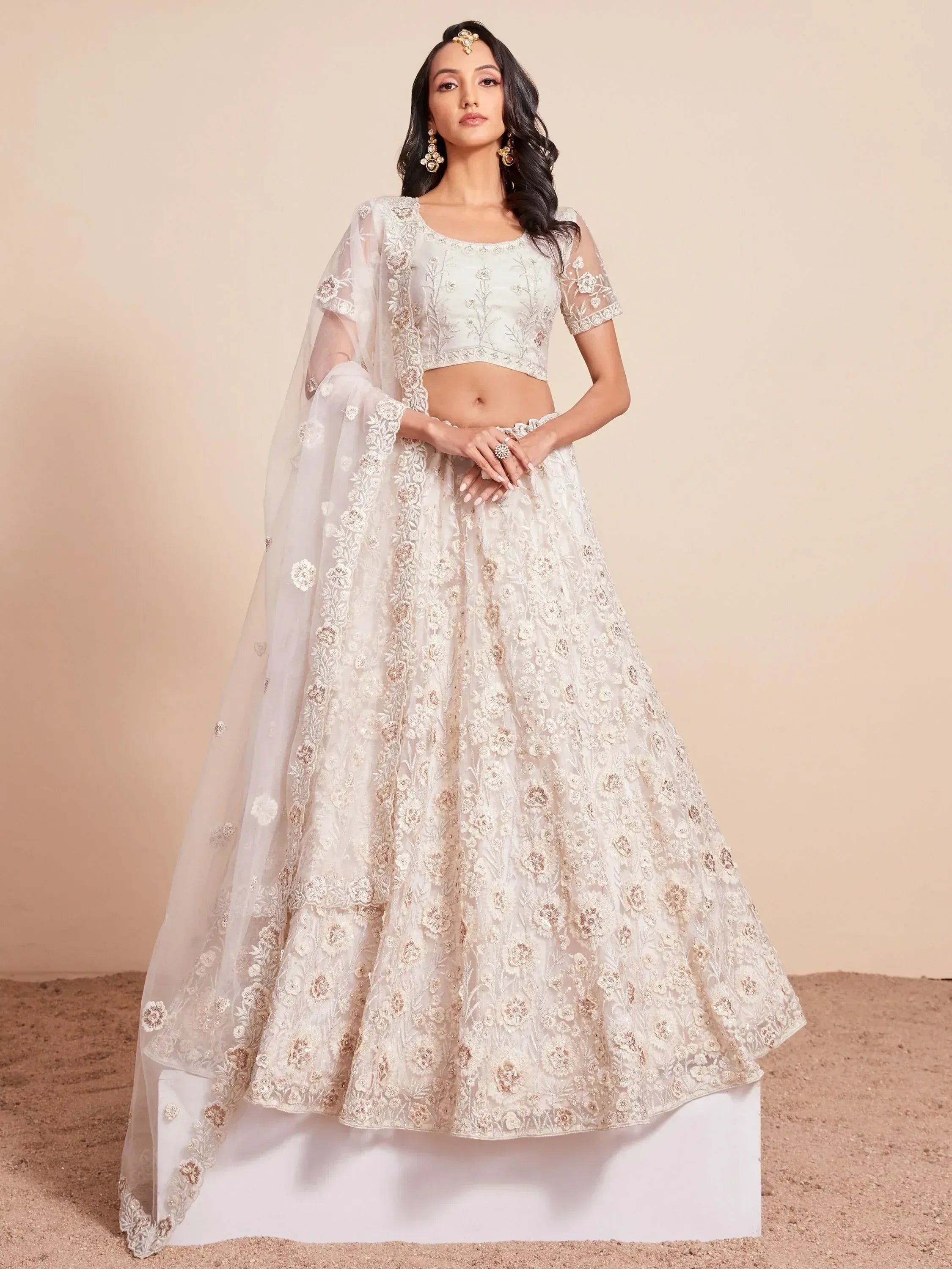 Elegant white floral embroidered lehenga choli with sheer dupatta, perfect for Indian weddings and festive occasions.