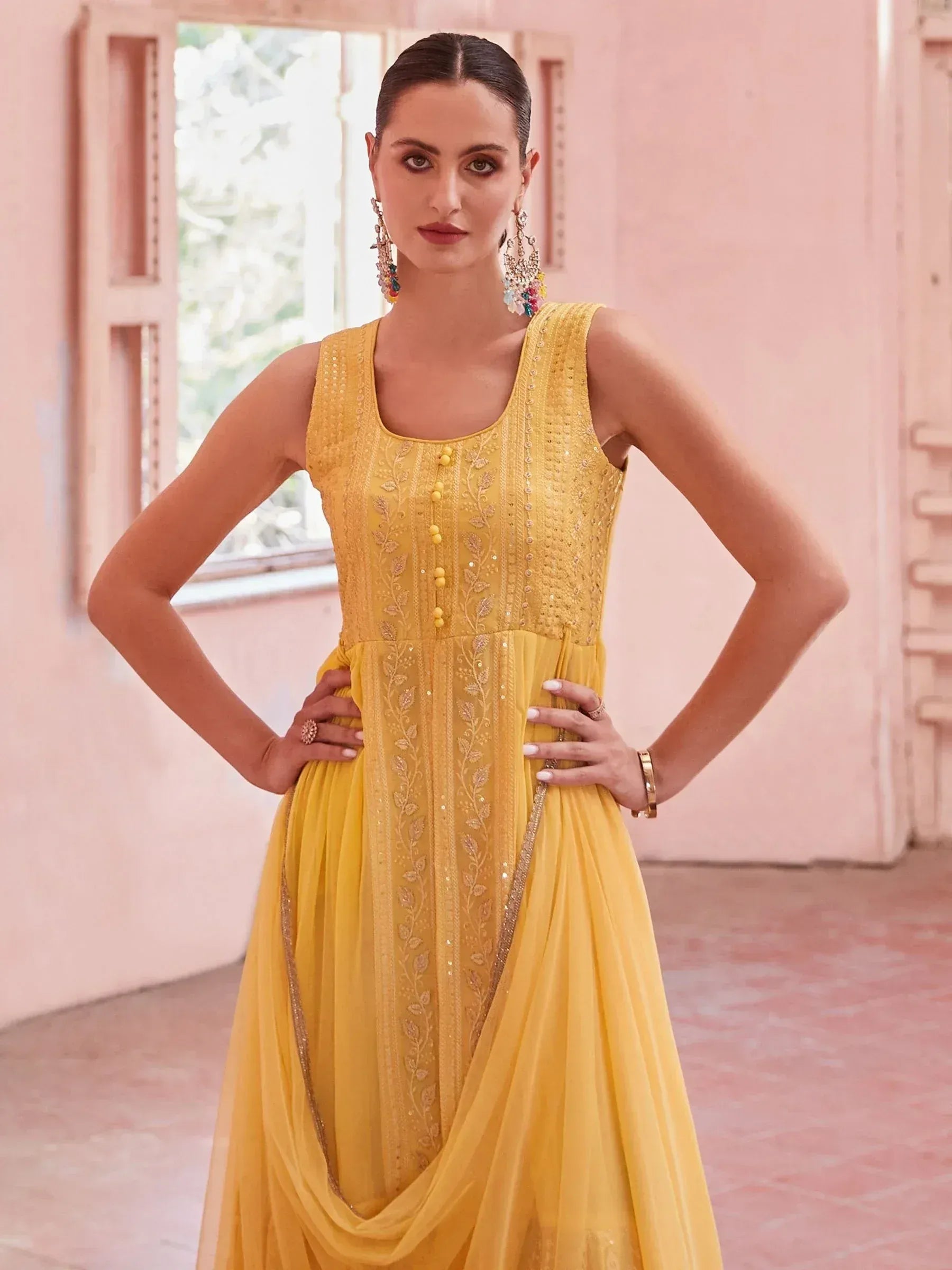 Yellow embroidered ethnic gown with floral detailing, perfect for Indian festive occasions