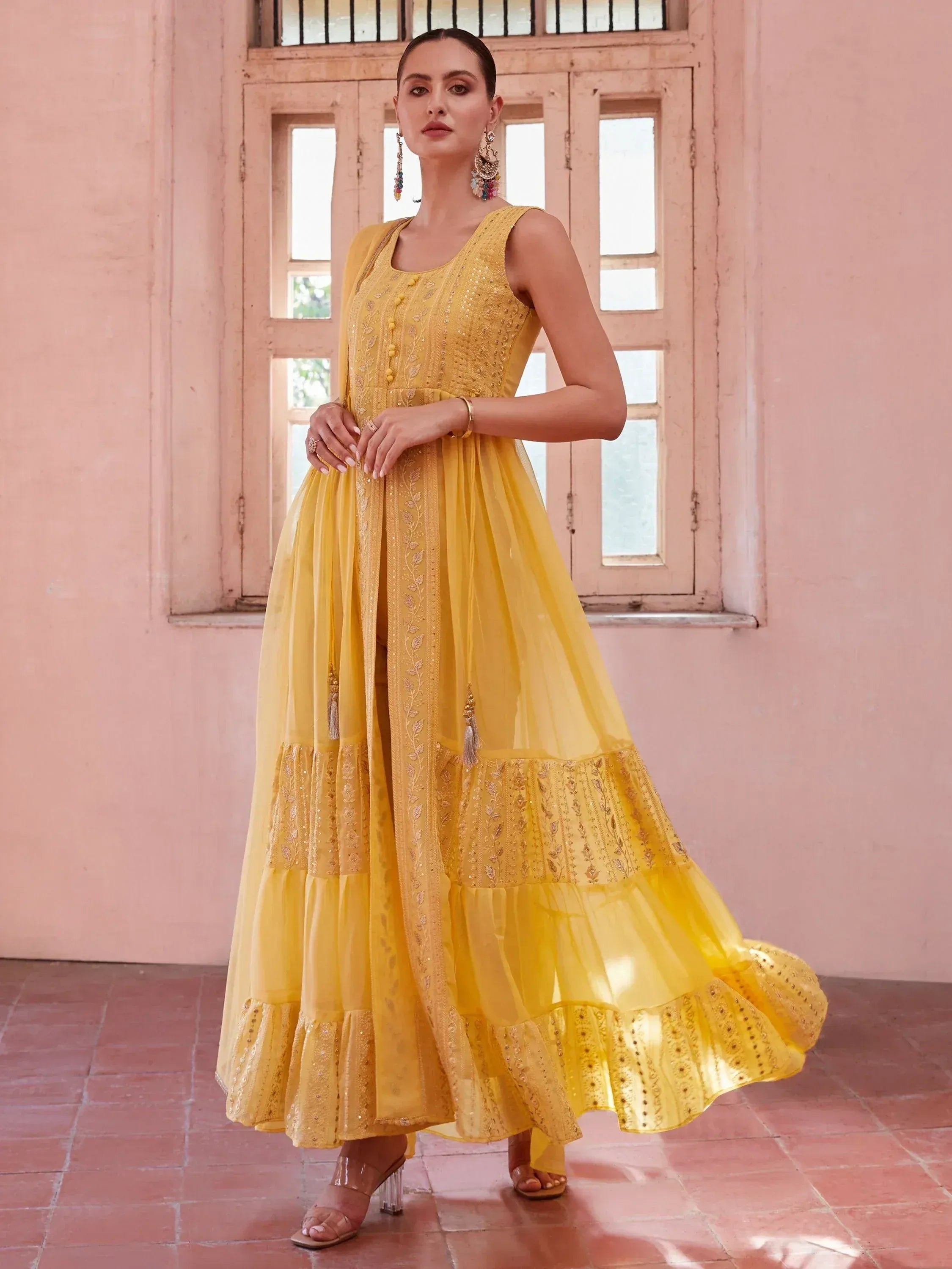 Yellow embroidered ethnic gown with layered skirt and dupatta, perfect for Indian occasions