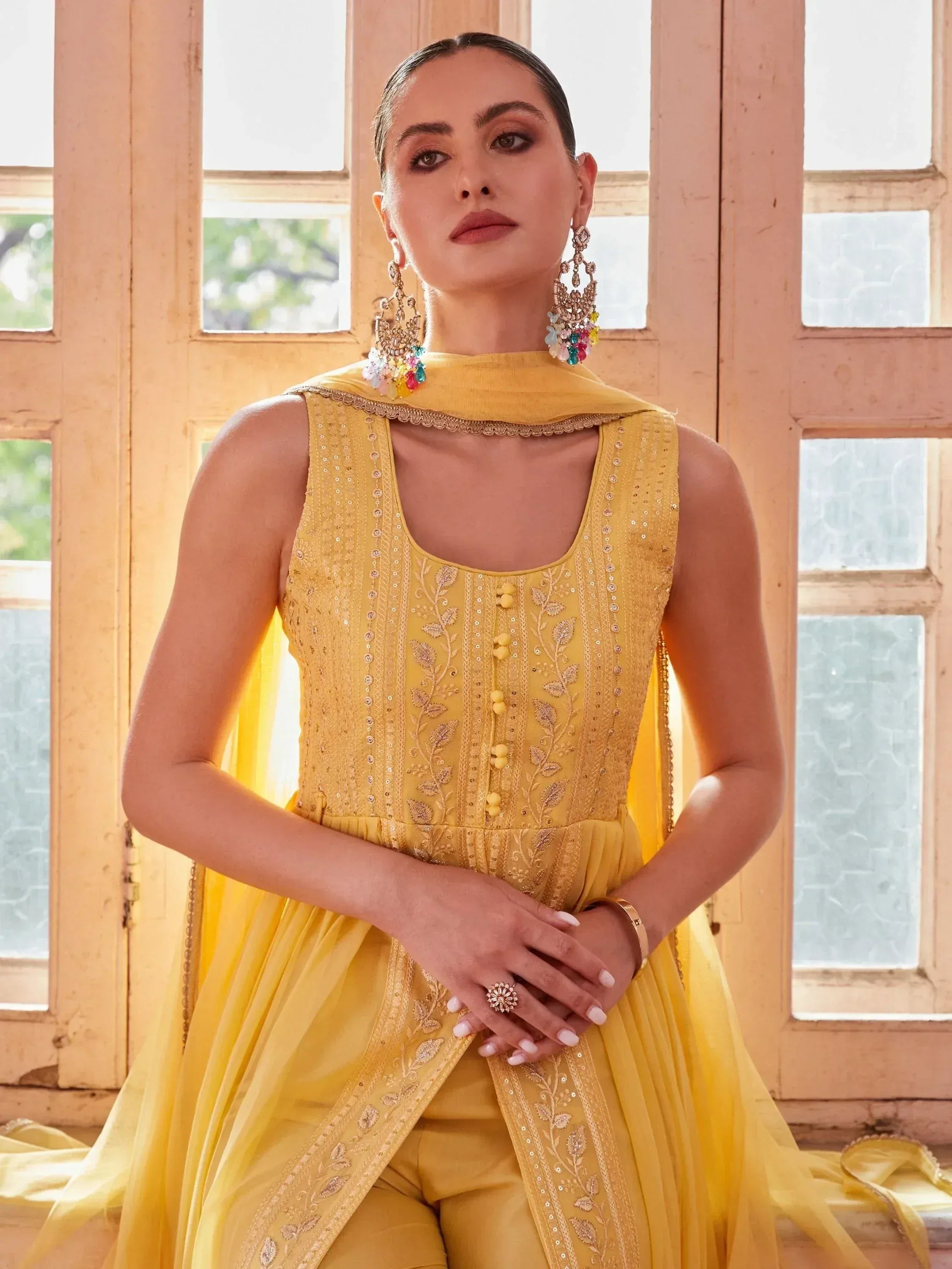 Yellow embroidered designer ethnic gown with matching dupatta and statement earrings
