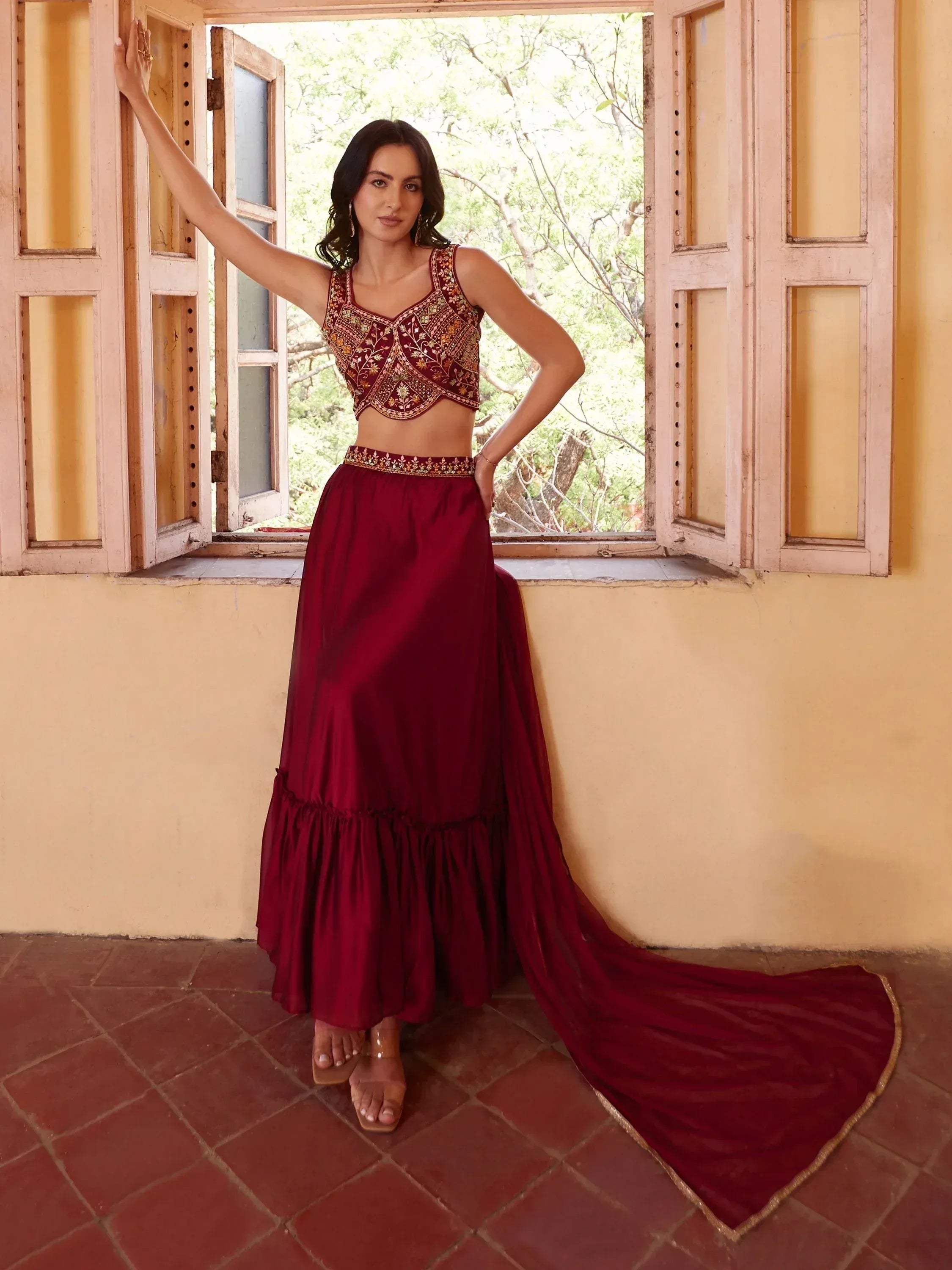 Maroon embroidered lehenga choli with long train, perfect for Indian ethnic wear occasions