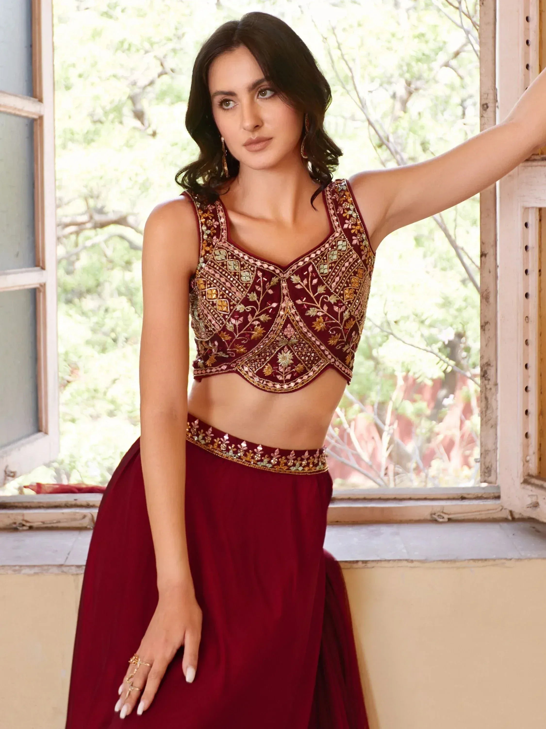 Maroon embroidered lehenga choli with gold detailing, perfect for Indian ethnic wear occasions