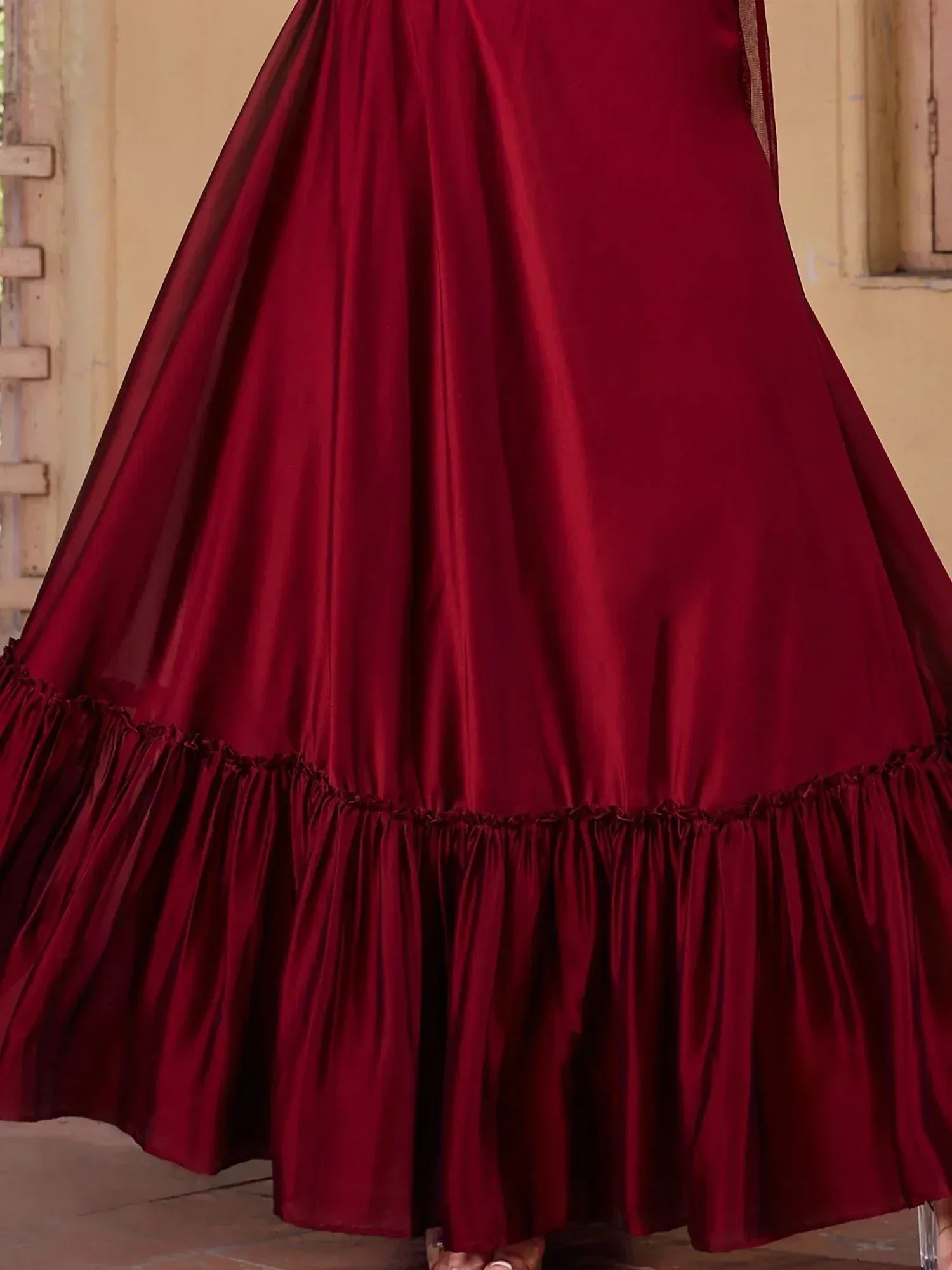 Rich maroon ethnic gown with ruffled hem, perfect for Indian festive occasions and weddings