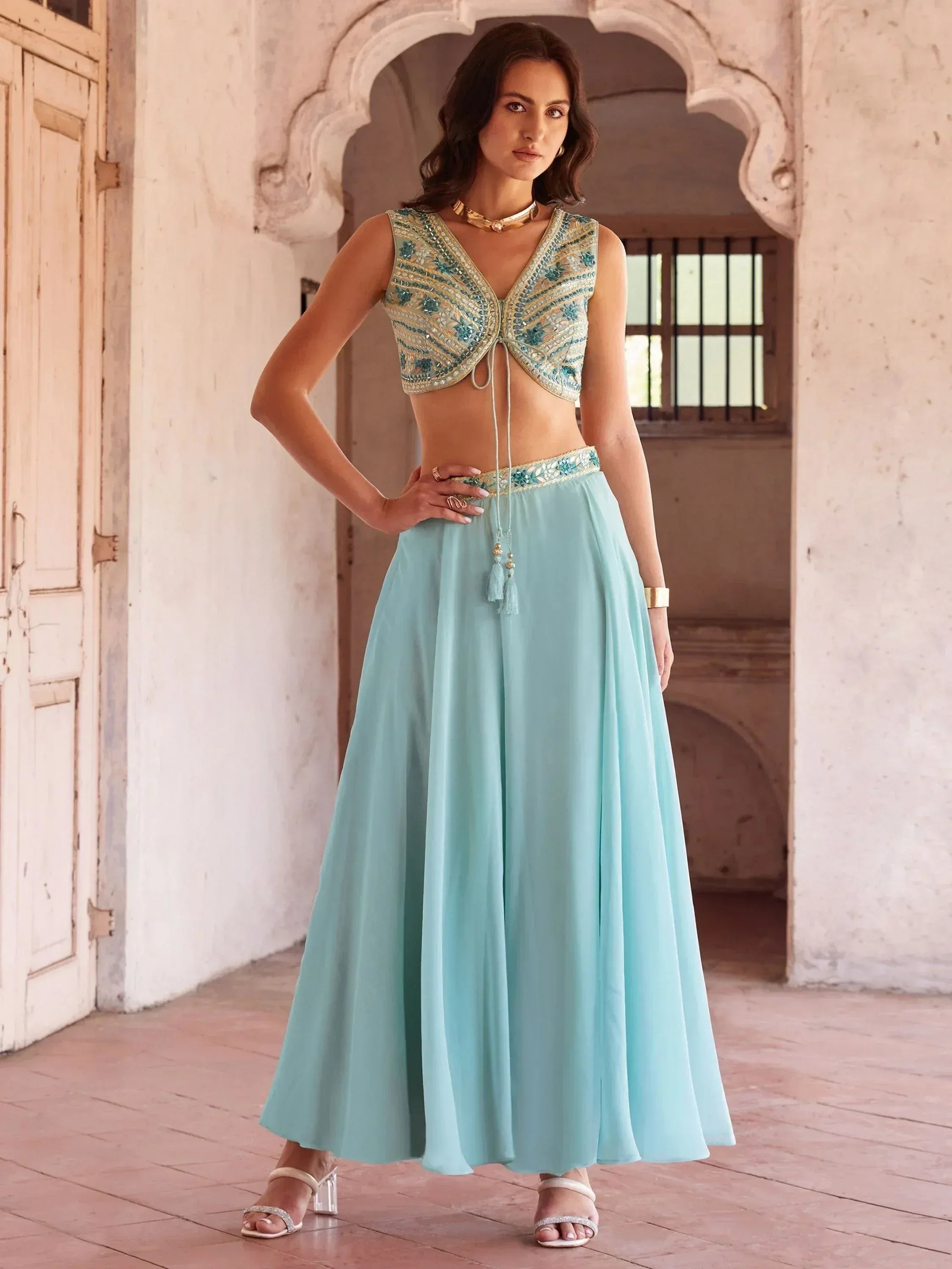 Mint blue embroidered lehenga choli with gold detailing, perfect for Indian ethnic wear occasions.
