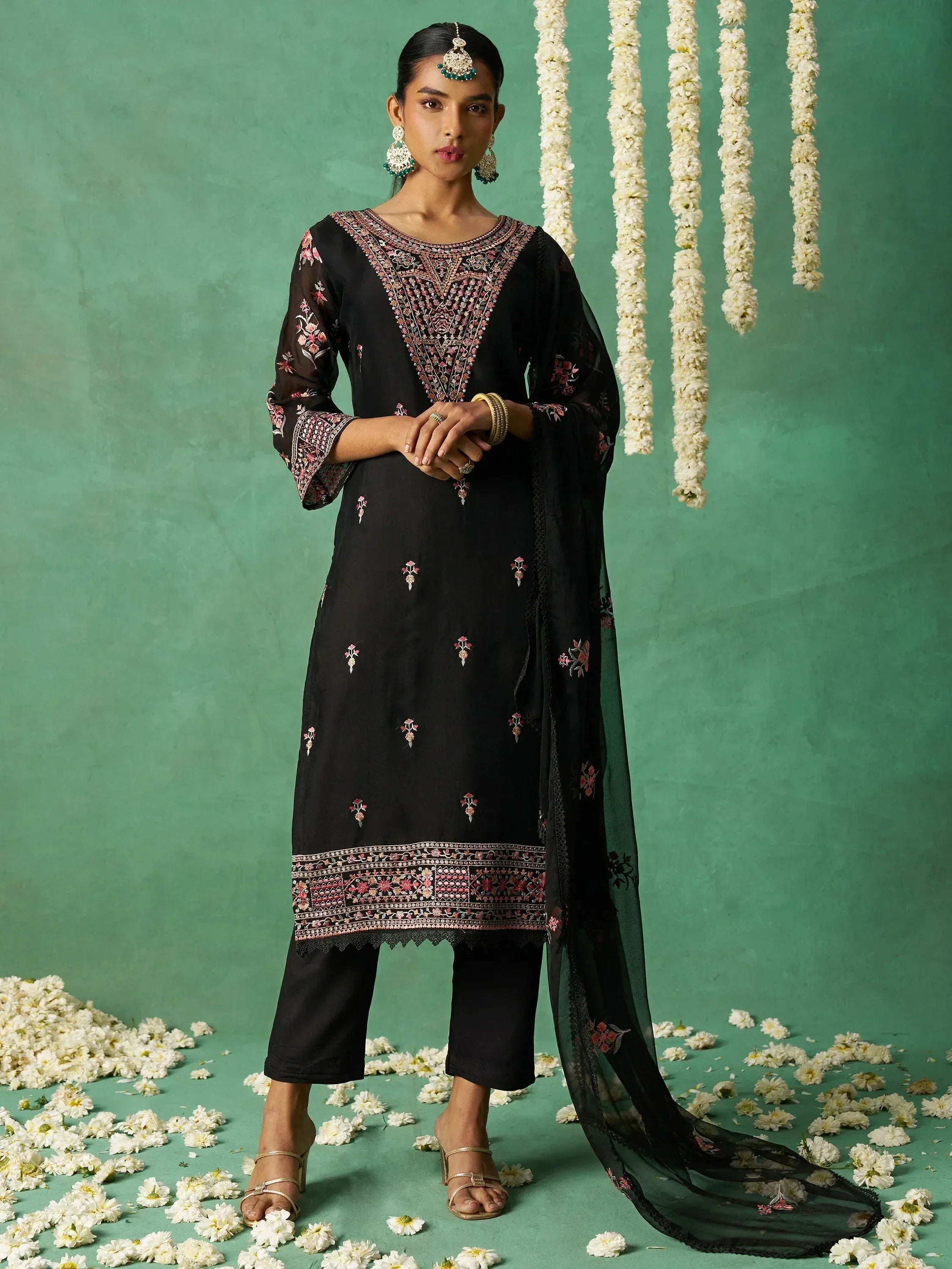 Black embroidered salwar kameez with floral motifs, paired with matching dupatta, perfect for ethnic occasions.