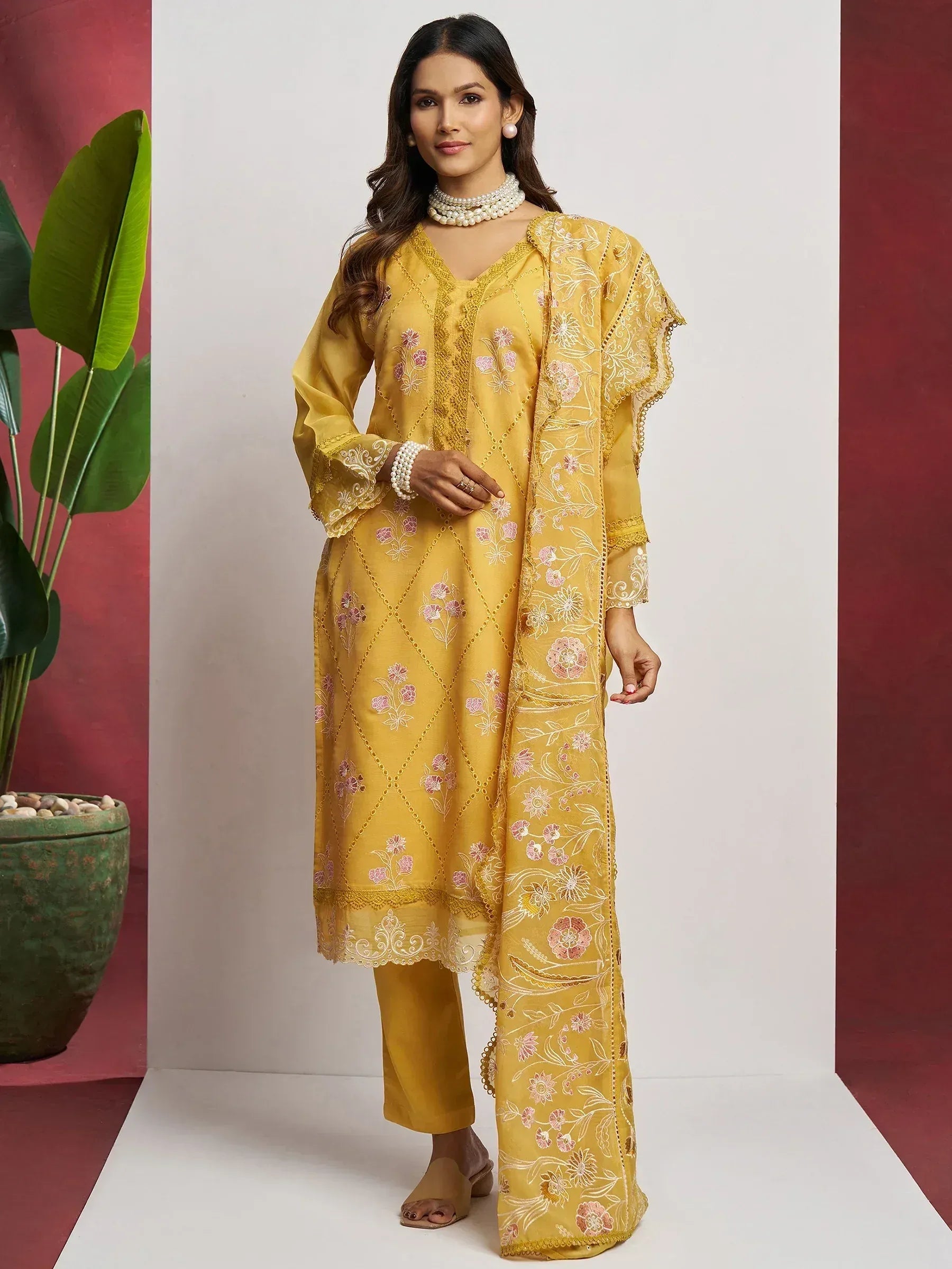 Yellow embroidered salwar kameez with floral design, perfect for Indian ethnic wear occasions