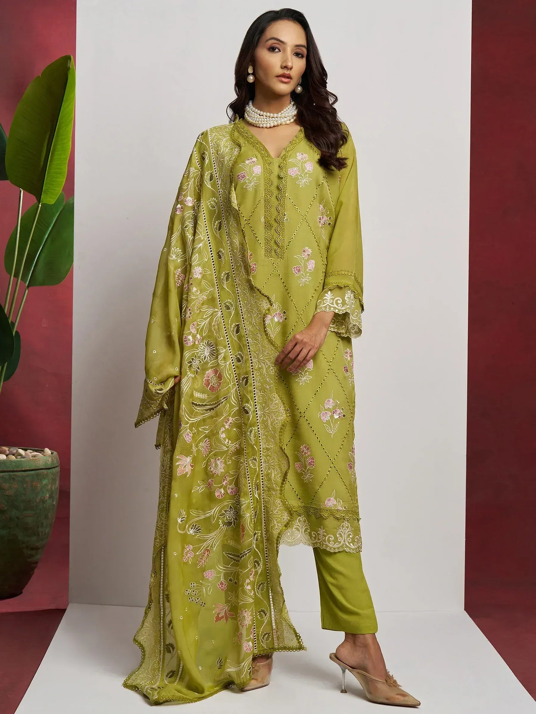 Green embroidered salwar kameez with floral print and lace detailing, perfect for ethnic occasions.
