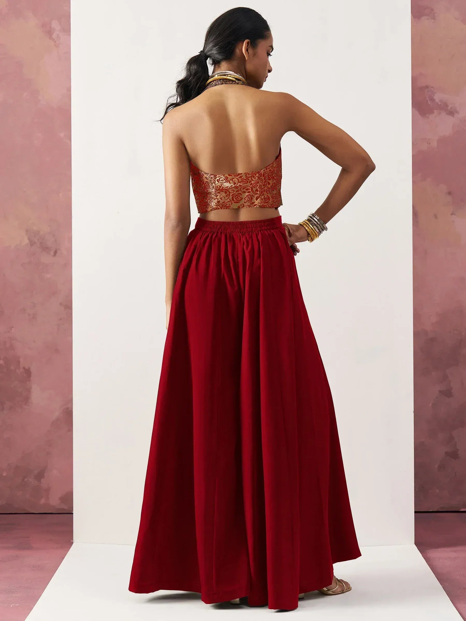 Red ethnic gown with gold embroidered crop top, back view, Indian designer wear