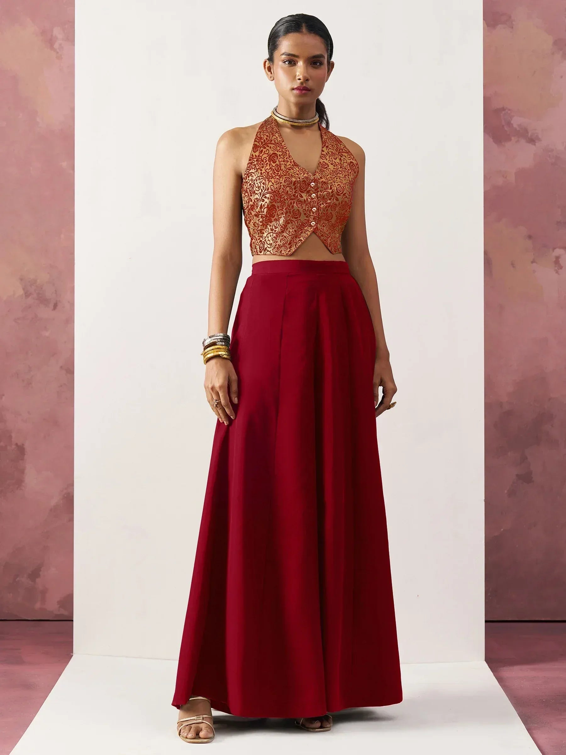 Red ethnic gown with gold embroidered halter top, perfect for Indian weddings and festive occasions