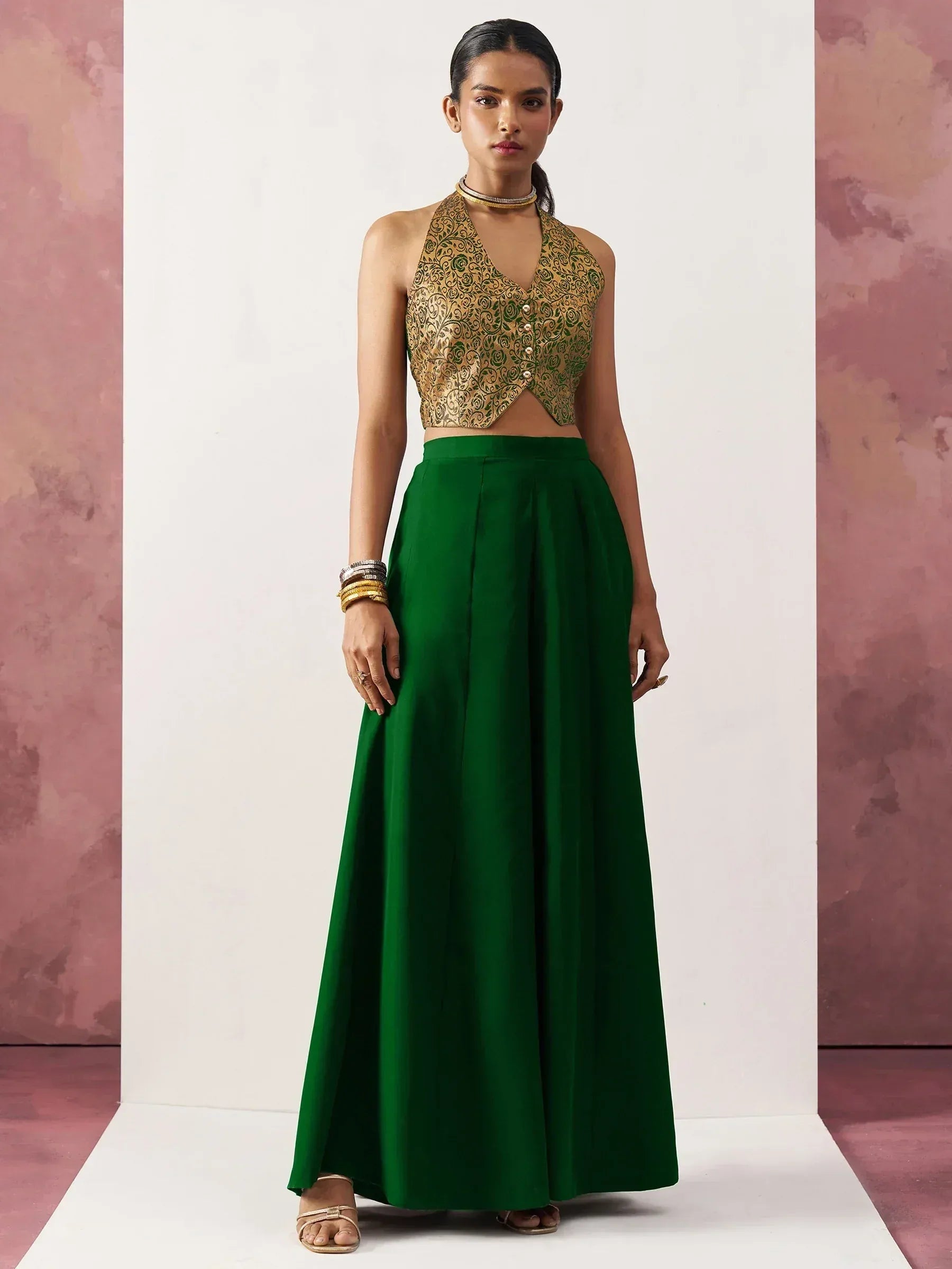 Emerald green ethnic gown with gold floral crop top, perfect for Indian festive occasions
