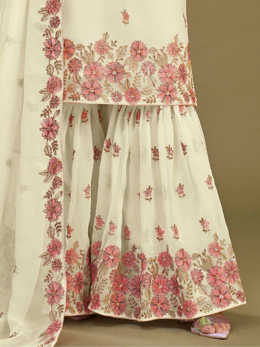 Cream floral embroidered lehenga choli with pink blossoms, perfect for ethnic occasions