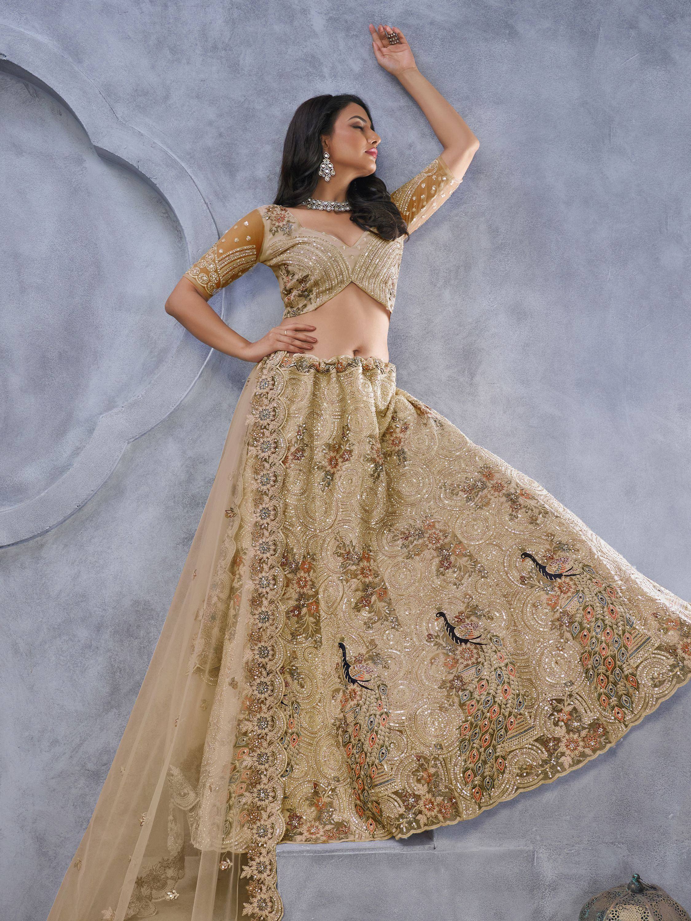 Elegant gold lehenga choli with intricate embroidery and peacock motifs, perfect for Indian weddings and festive occasions.