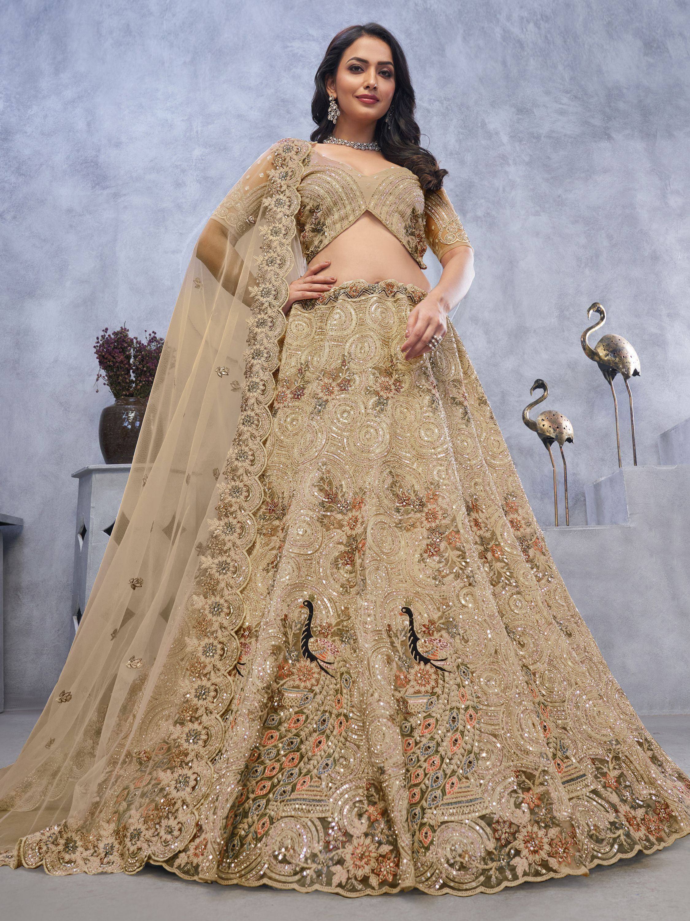 Gold embroidered lehenga choli with peacock motifs, perfect for Indian weddings and festive occasions.