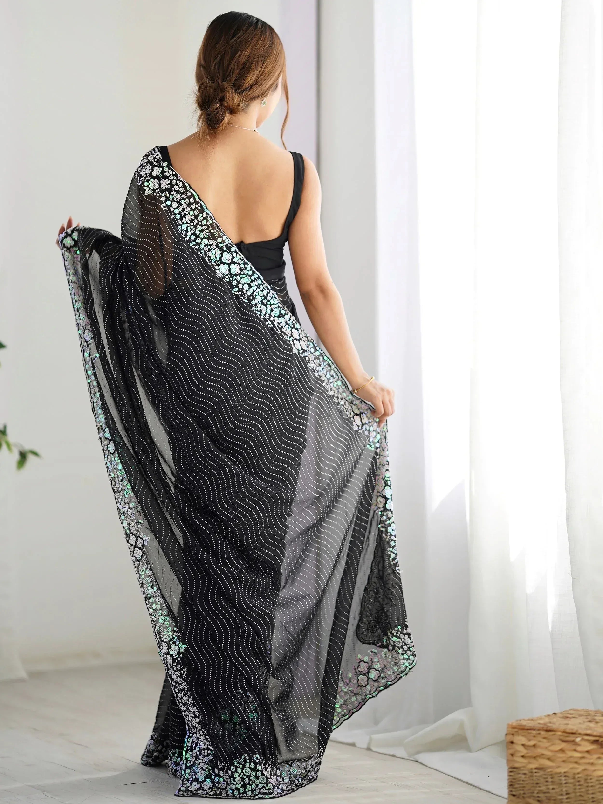 Black sheer ethnic gown with sequin floral border, backless design, perfect for Indian occasions