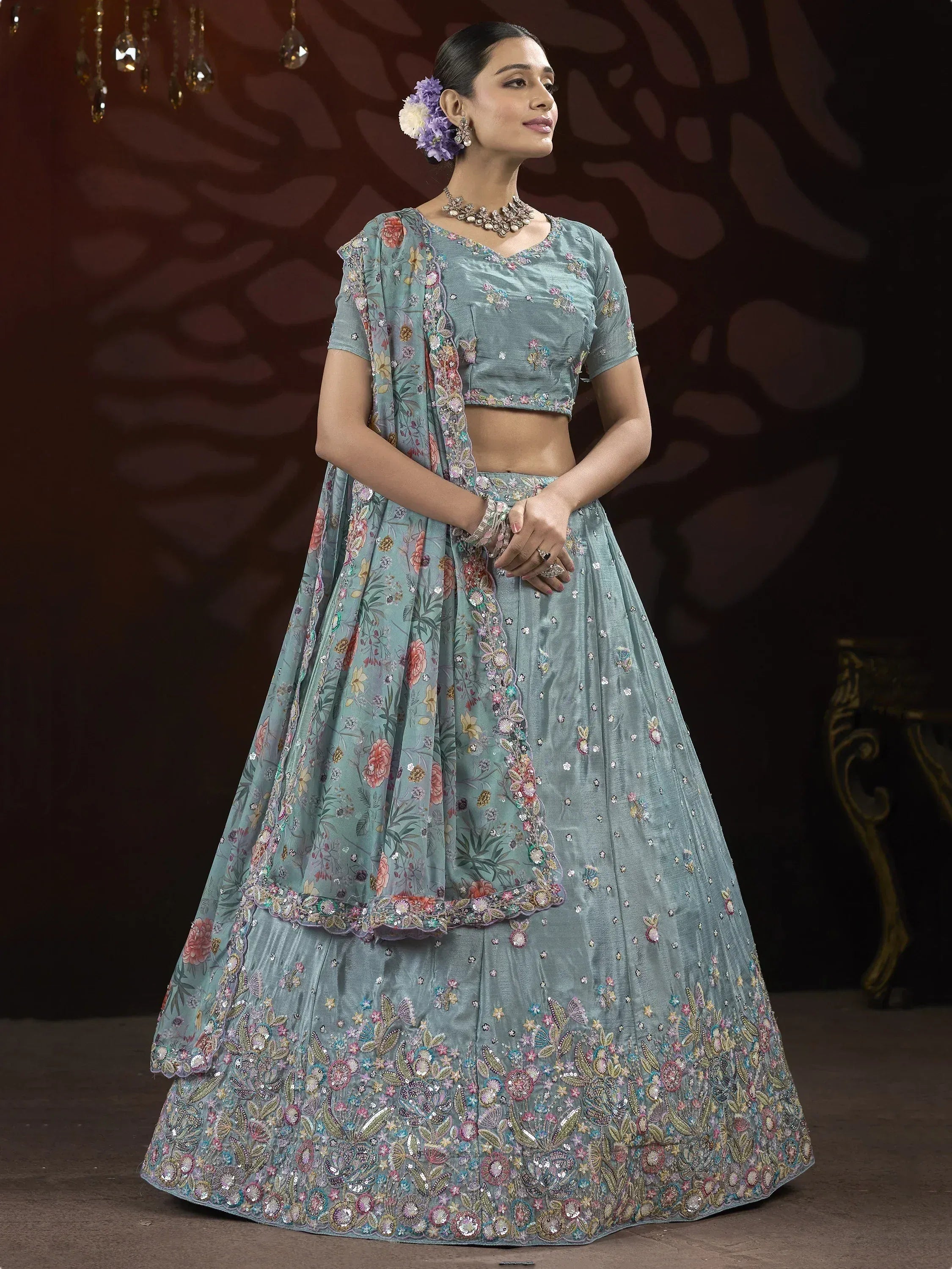 Elegant teal lehenga choli with floral embroidery and sequin work, perfect for Indian weddings and festive occasions.