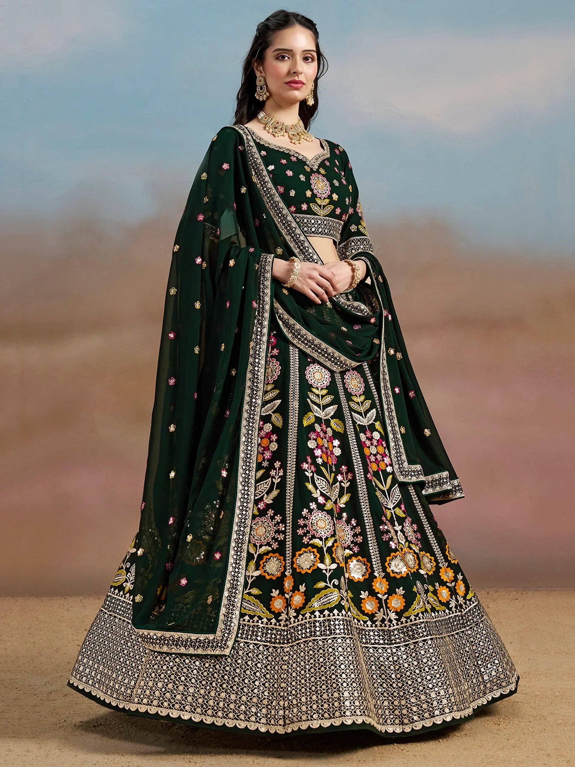 Emerald green embroidered lehenga choli with floral motifs and gold detailing, perfect for Indian ethnic wear.
