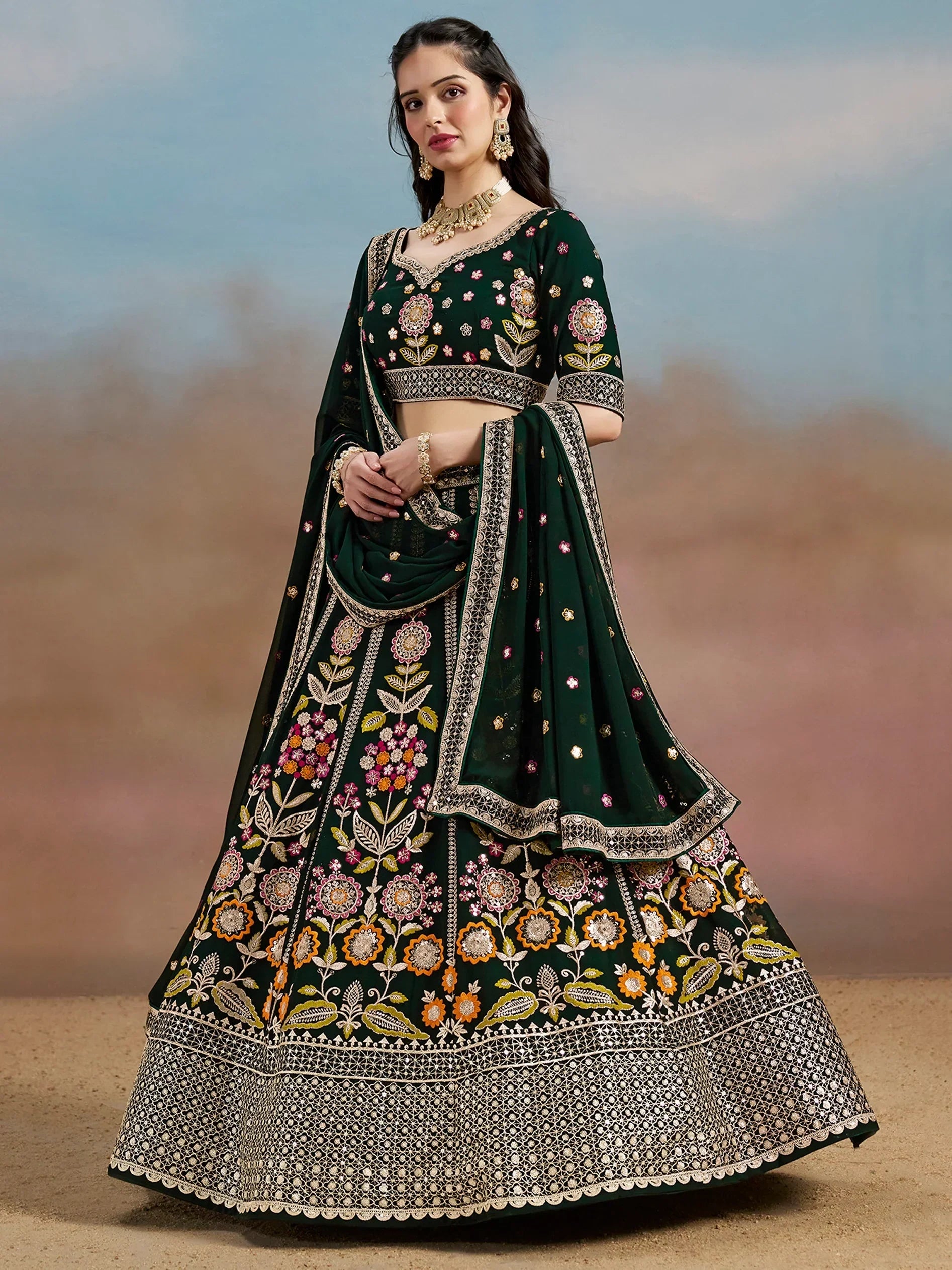 Emerald green embroidered lehenga choli with floral motifs and gold detailing, perfect for Indian weddings and festive occasions.