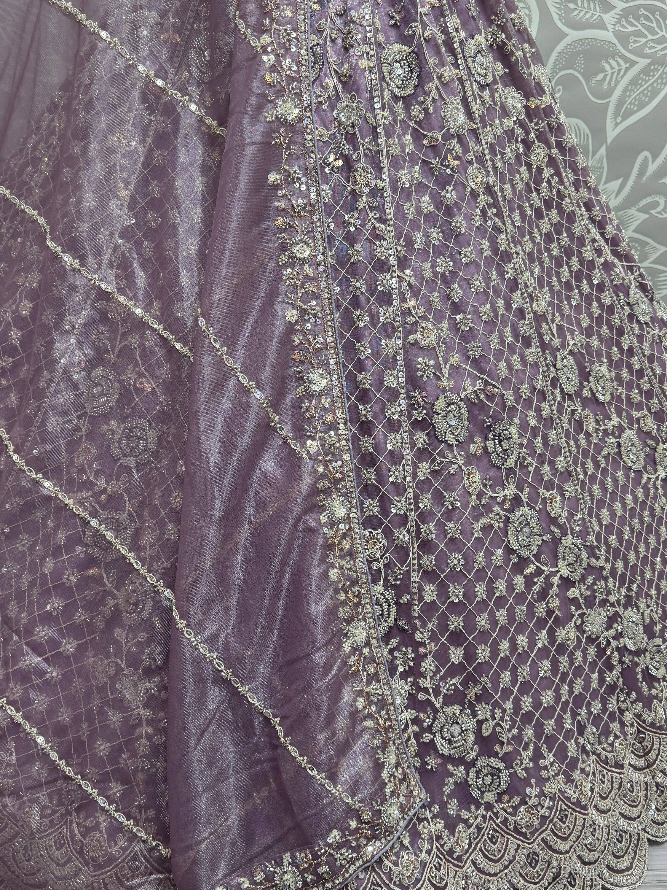 Purple designer lehenga with intricate gold embroidery and sequin work, perfect for Indian ethnic wear.