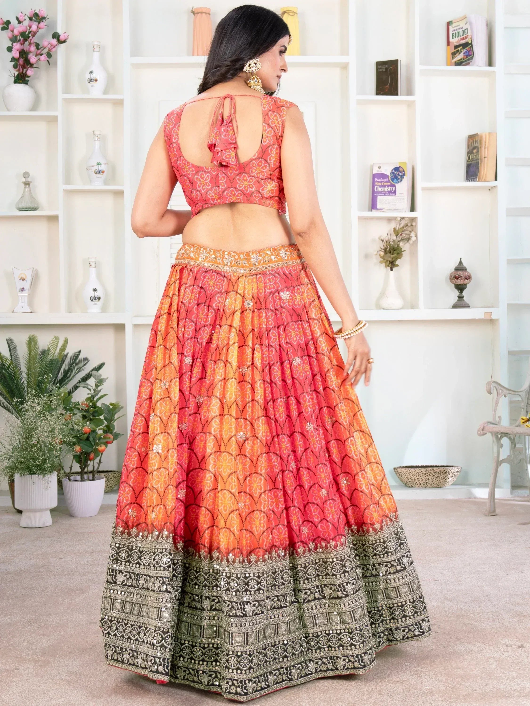 Orange and pink printed lehenga choli with embroidered border, back view