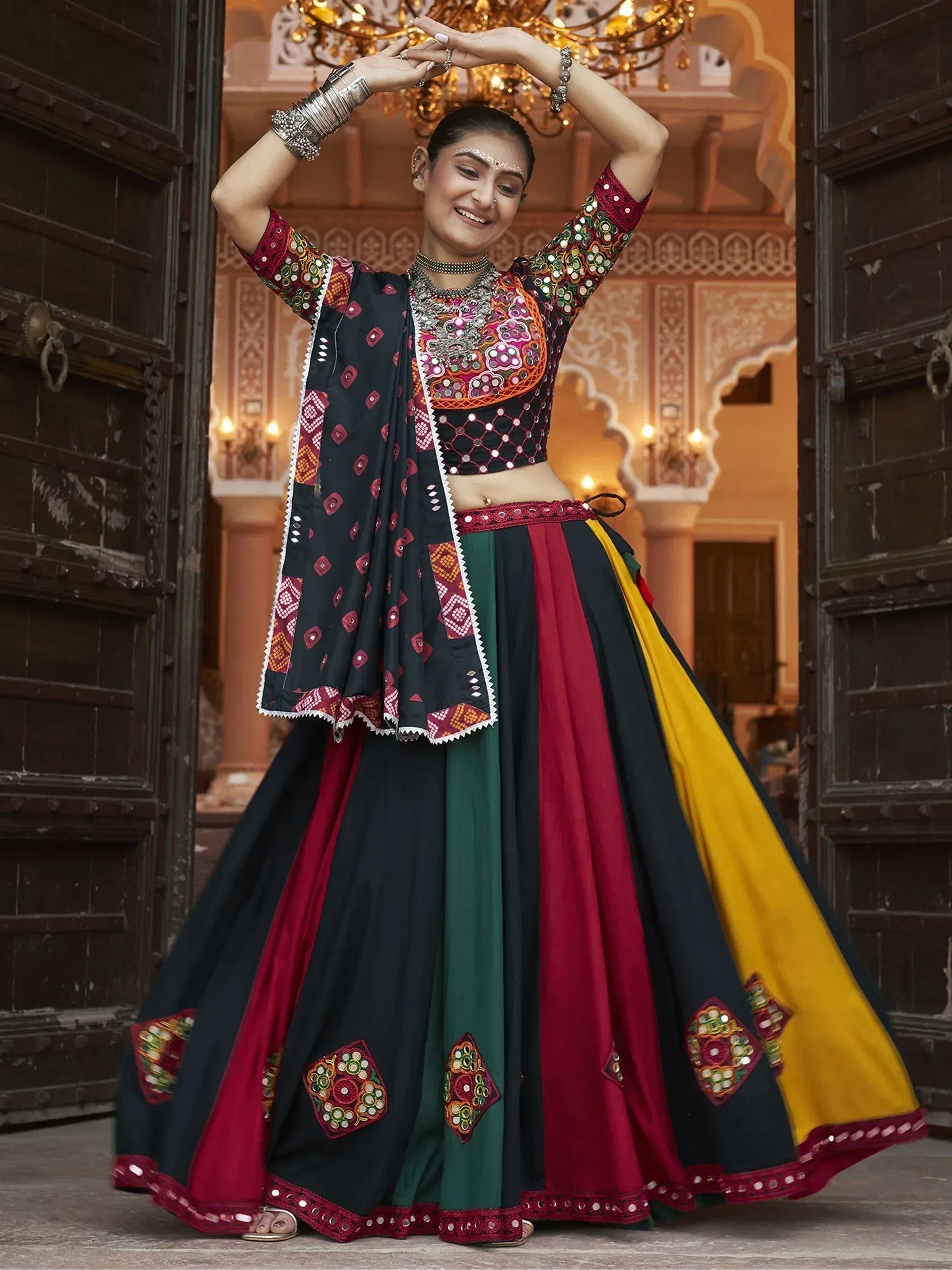 Woman in colorful embroidered lehenga choli with mirror work, traditional Indian ethnic wear
