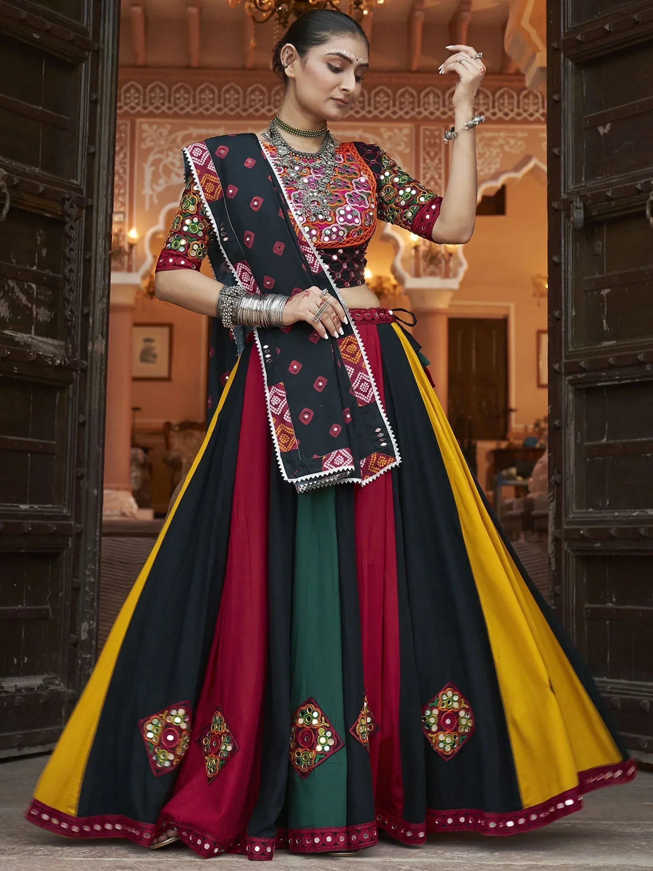 Woman in colorful embroidered lehenga choli with mirror work, traditional Indian ethnic wear