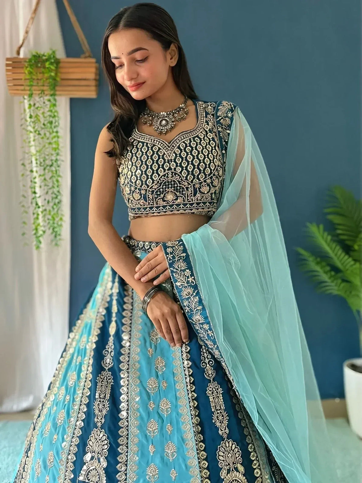 Blue embroidered lehenga choli with gold detailing and sheer dupatta, perfect for Indian ethnic wear occasions