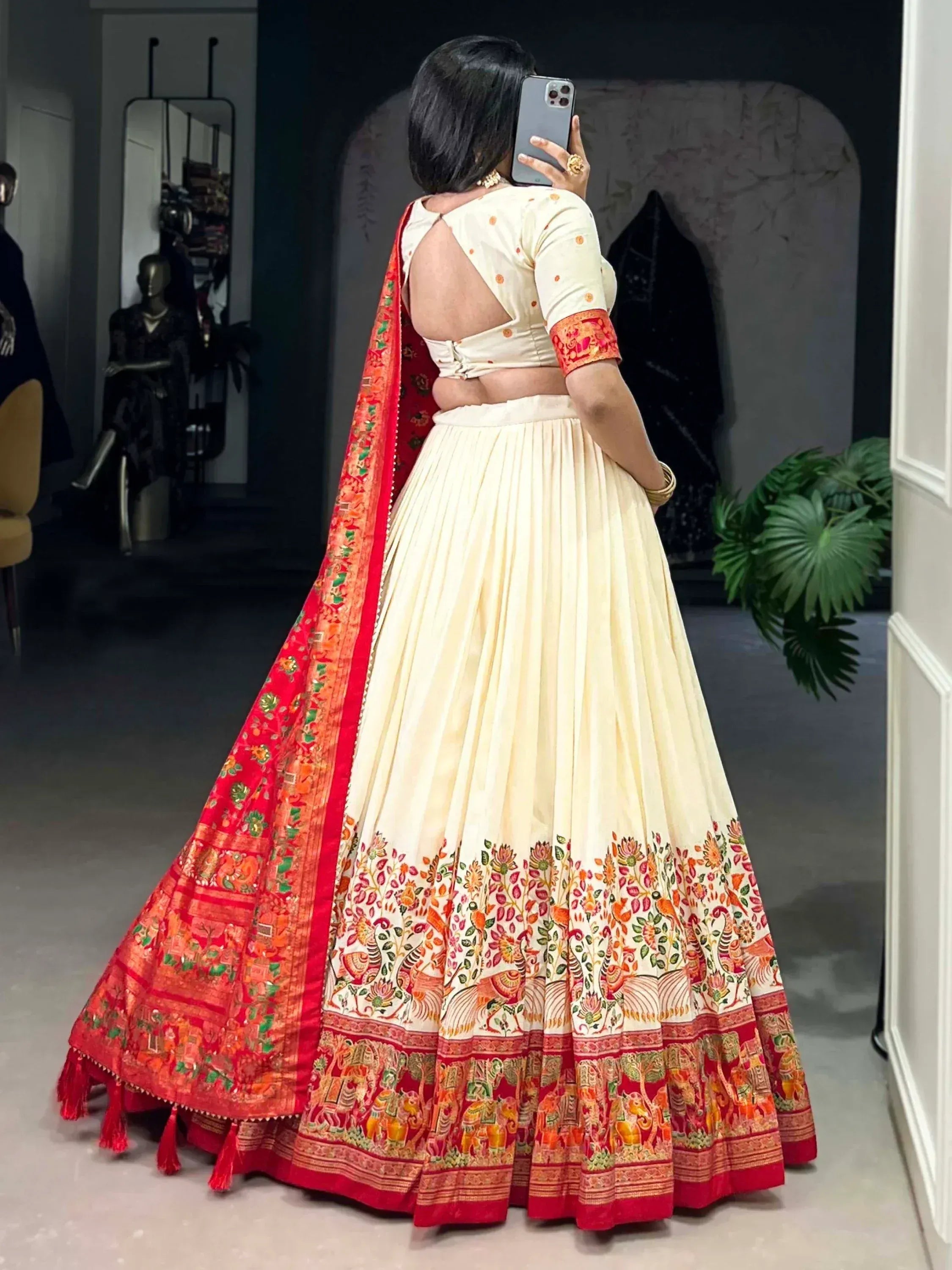 Cream lehenga choli with red floral border and backless blouse, perfect for Indian ethnic wear