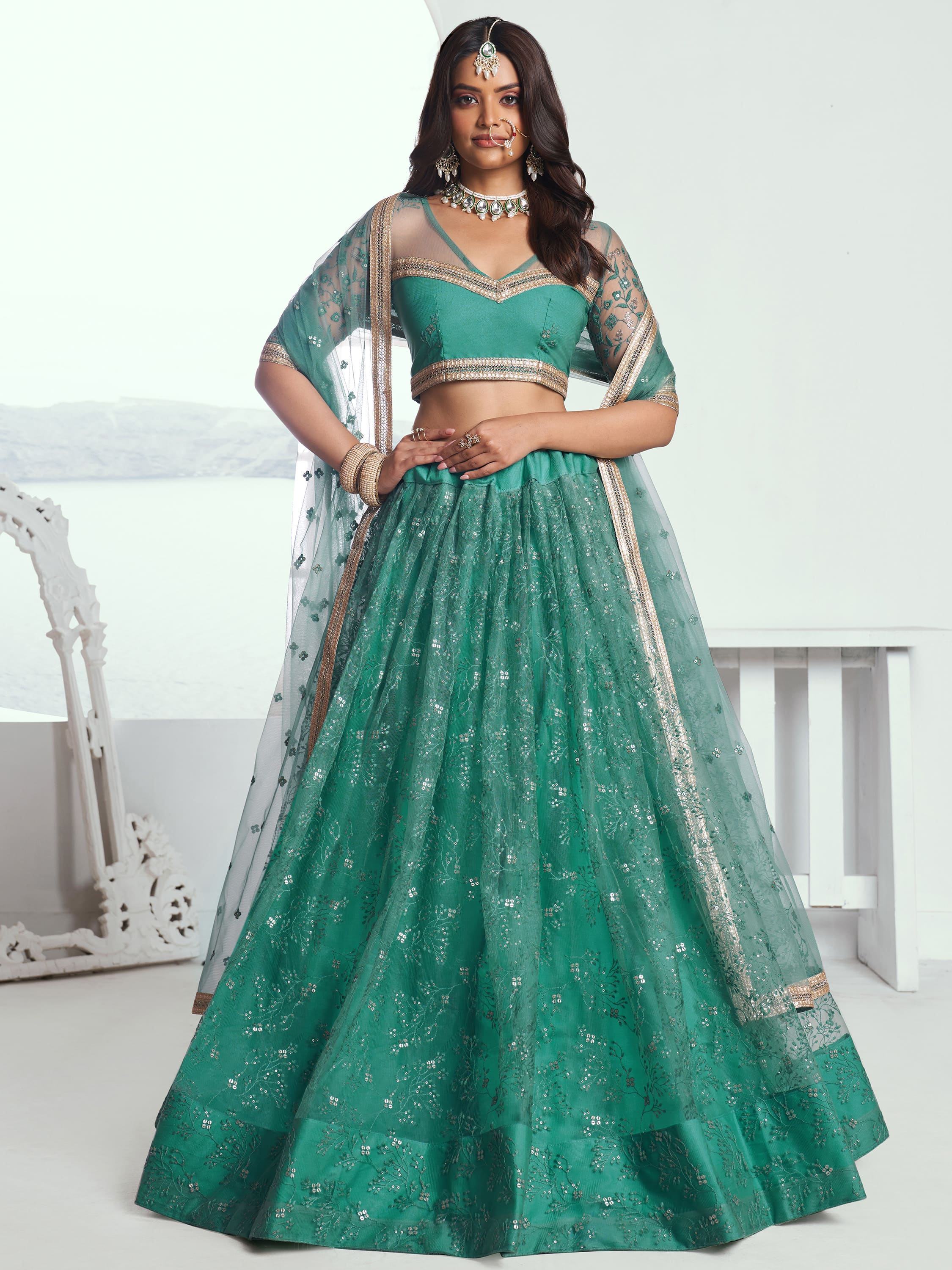 Emerald green designer lehenga choli with gold embroidery and sheer dupatta, perfect for Indian weddings and festive occasions.