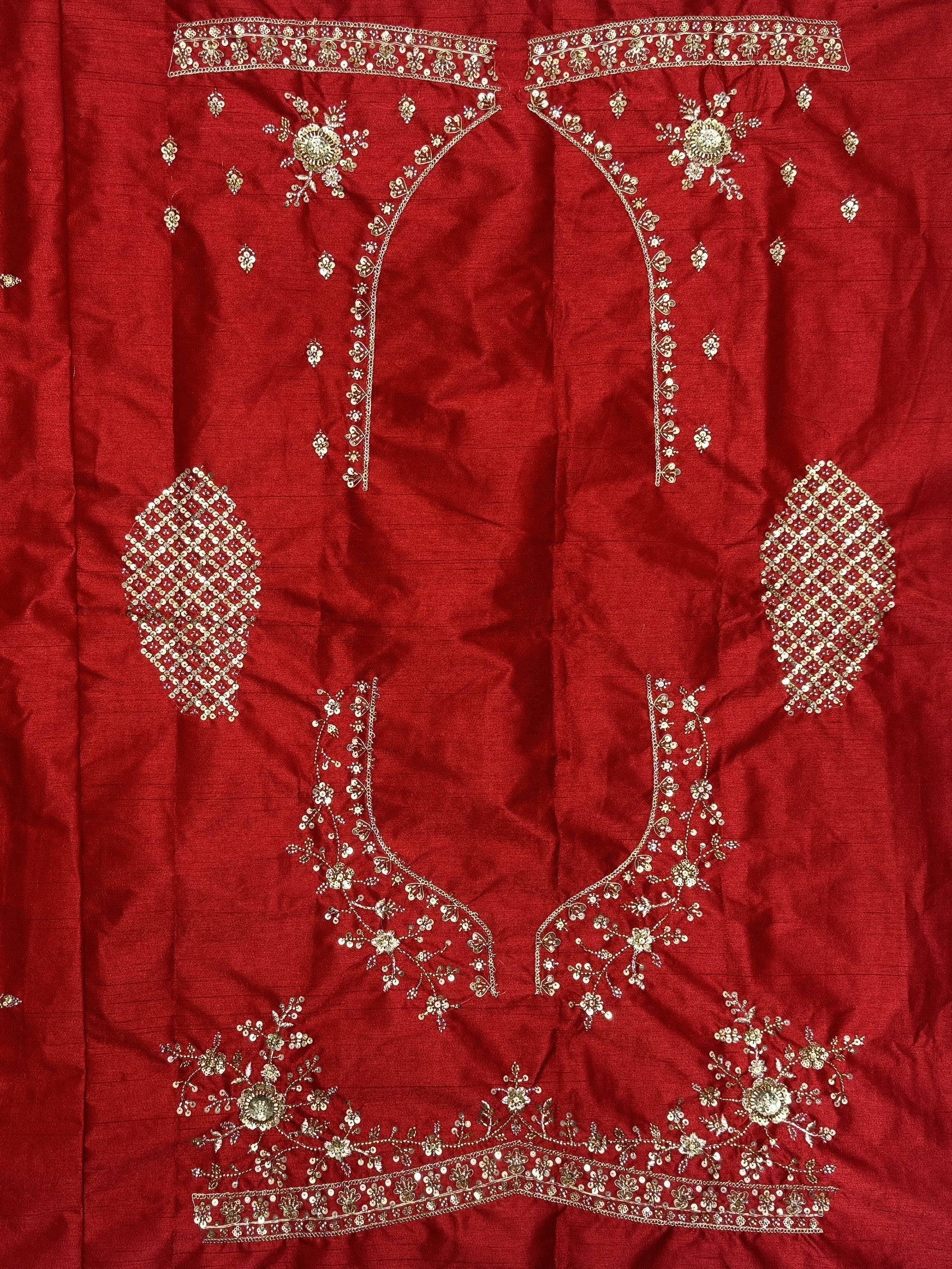 Red ethnic lehenga choli with gold floral embroidery and sequin work, perfect for Indian weddings and festive occasions.