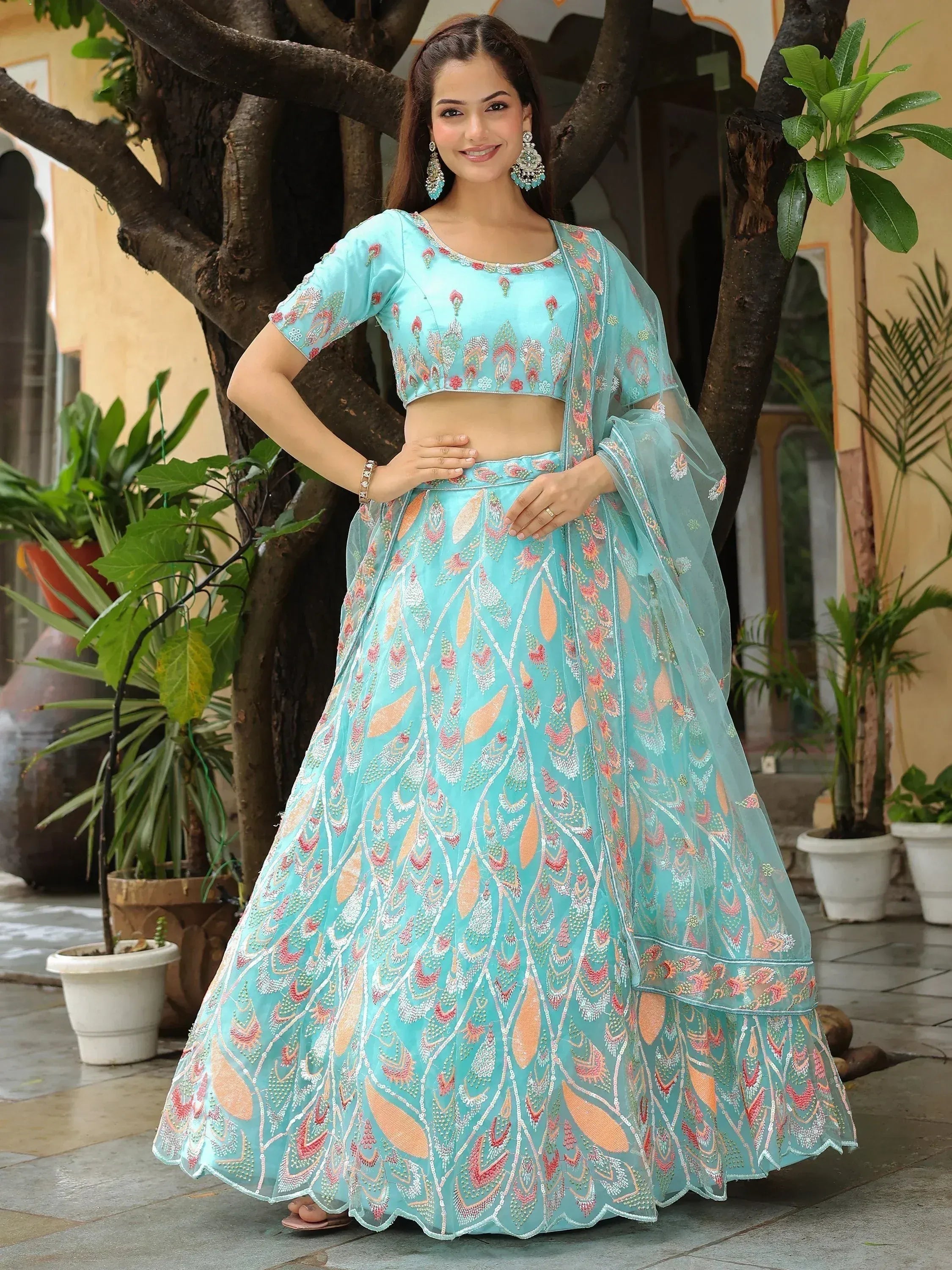 Turquoise embroidered lehenga choli with floral motifs, perfect for Indian ethnic occasions
