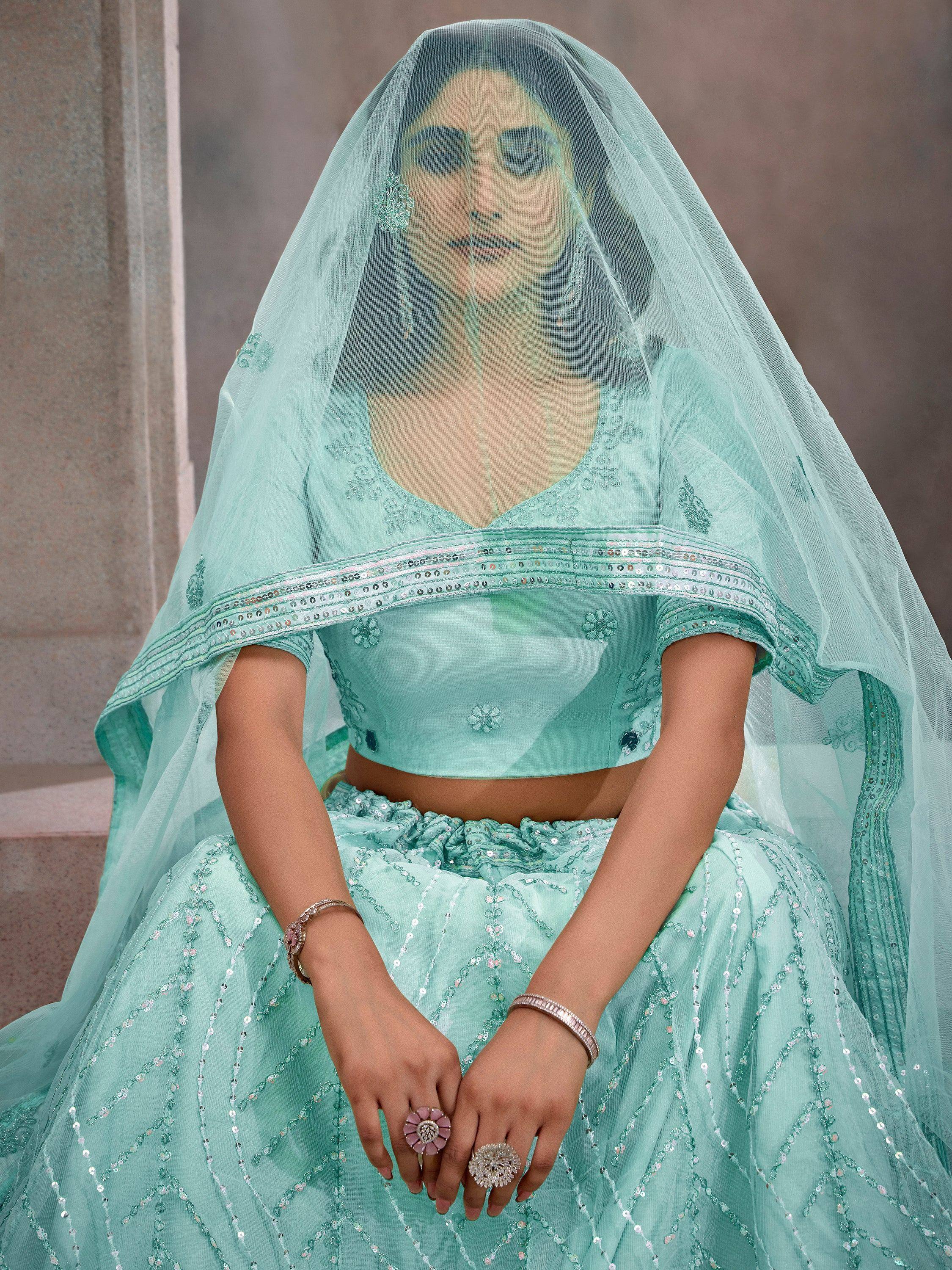 Mint green designer lehenga choli with sequin embroidery and sheer dupatta for Indian weddings
