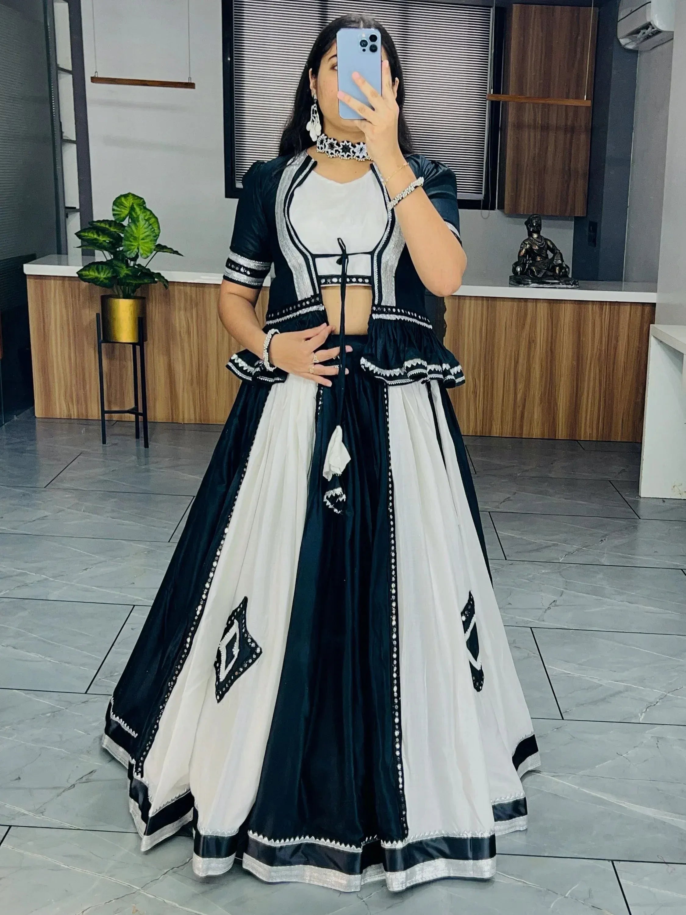 Black and white ethnic lehenga choli with silver embroidery, perfect for Indian festive occasions.