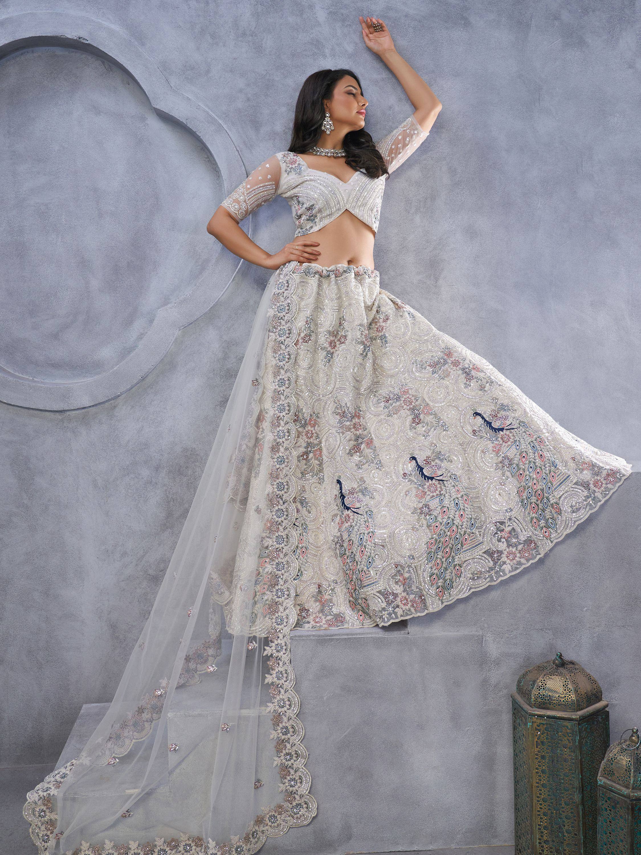 Elegant white lehenga choli with peacock embroidery, perfect for Indian ethnic wear and festive occasions.
