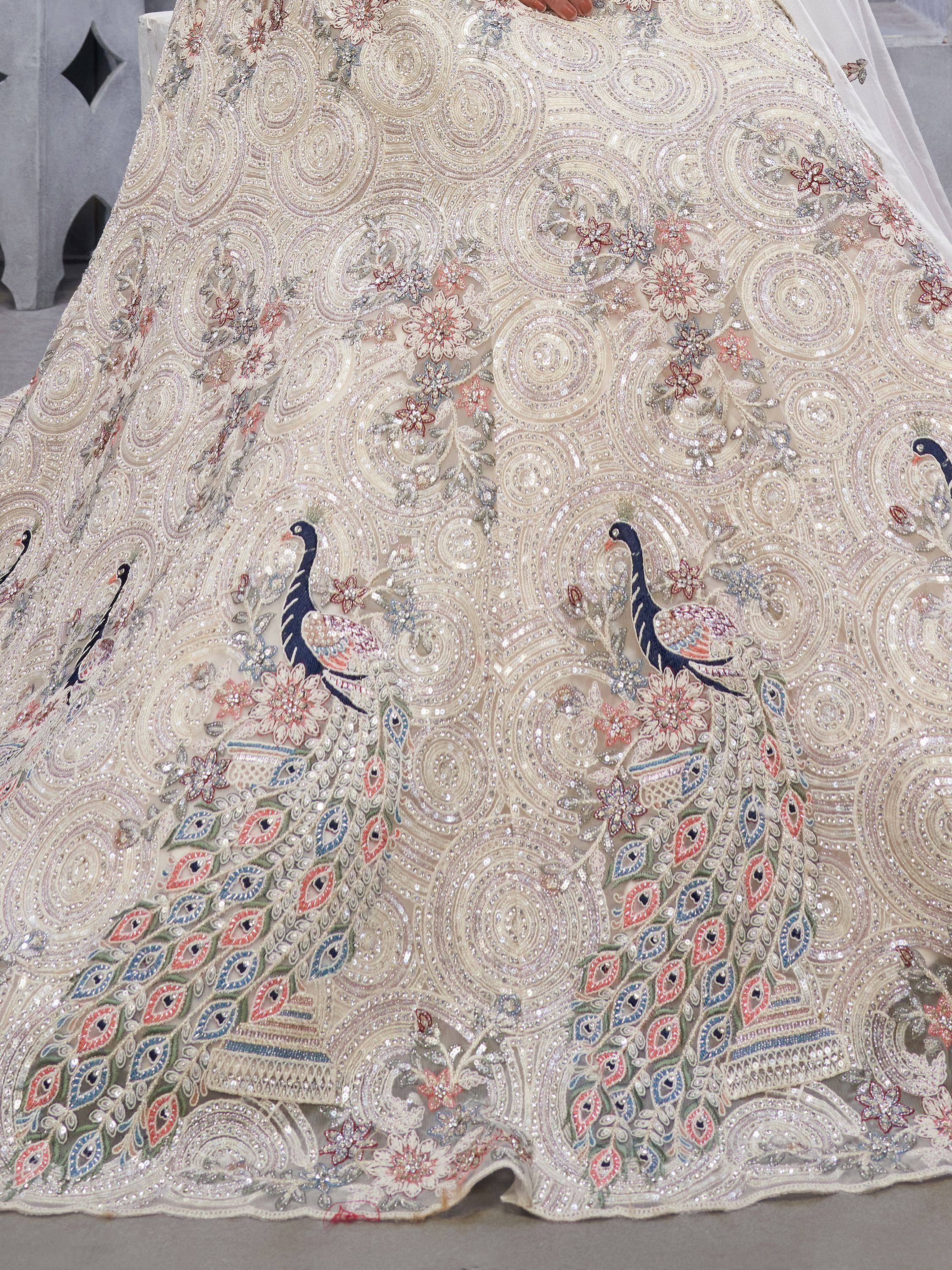 Designer lehenga with peacock embroidery, floral motifs, and sequin work for Indian ethnic wear