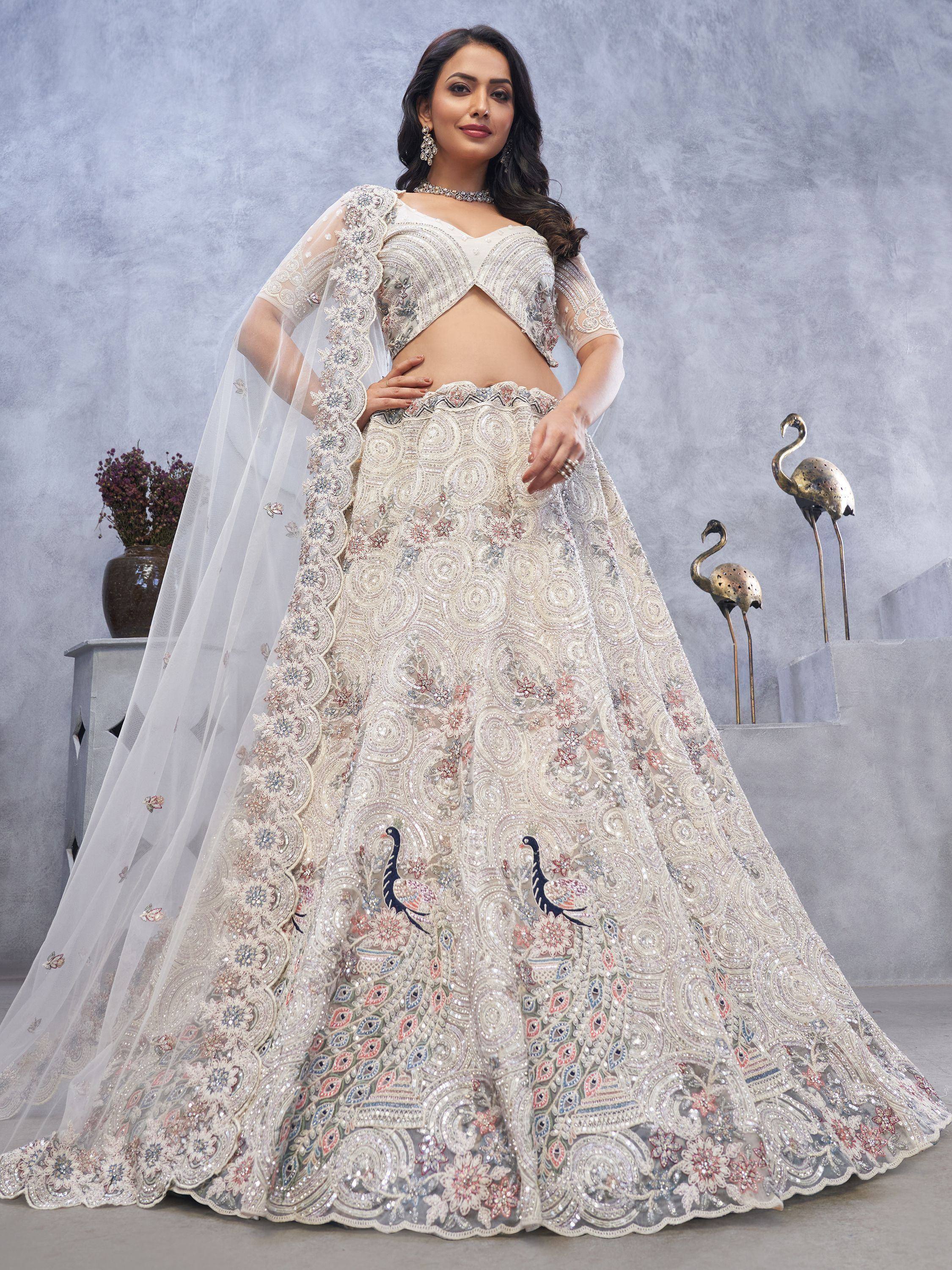 Elegant ivory lehenga choli with peacock embroidery, perfect for Indian weddings and festive occasions.