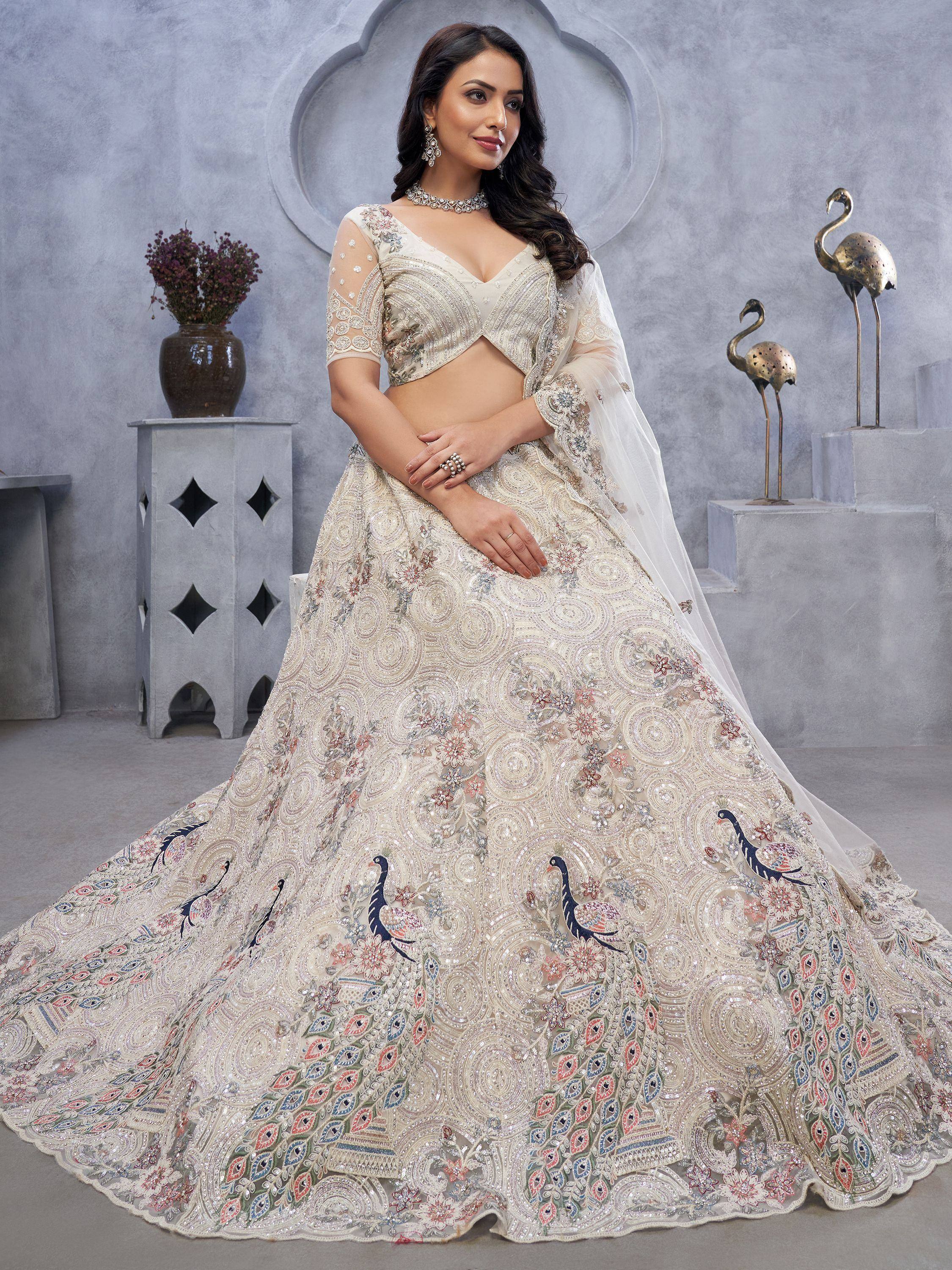 Elegant ivory lehenga choli with peacock embroidery, perfect for Indian weddings and festive occasions.
