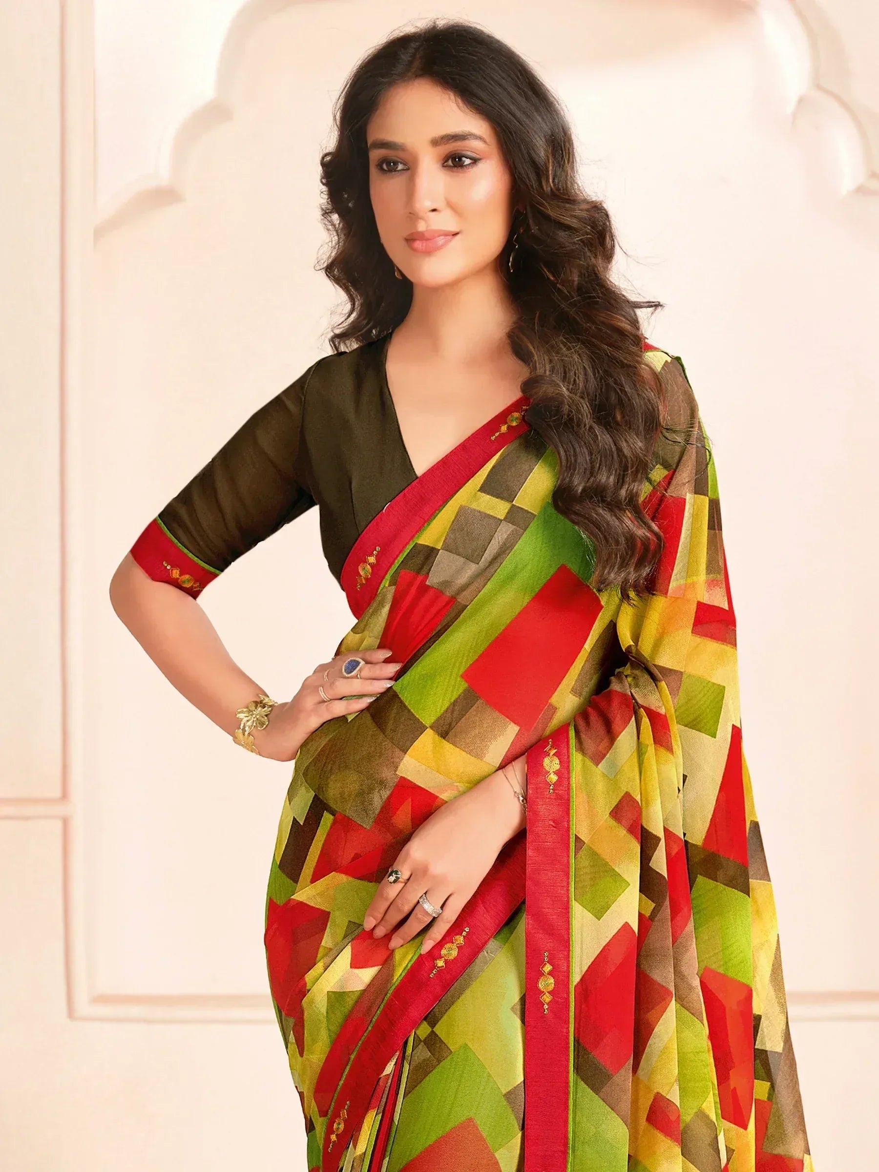 Woman in vibrant geometric print saree with red border and olive blouse, Indian ethnic wear