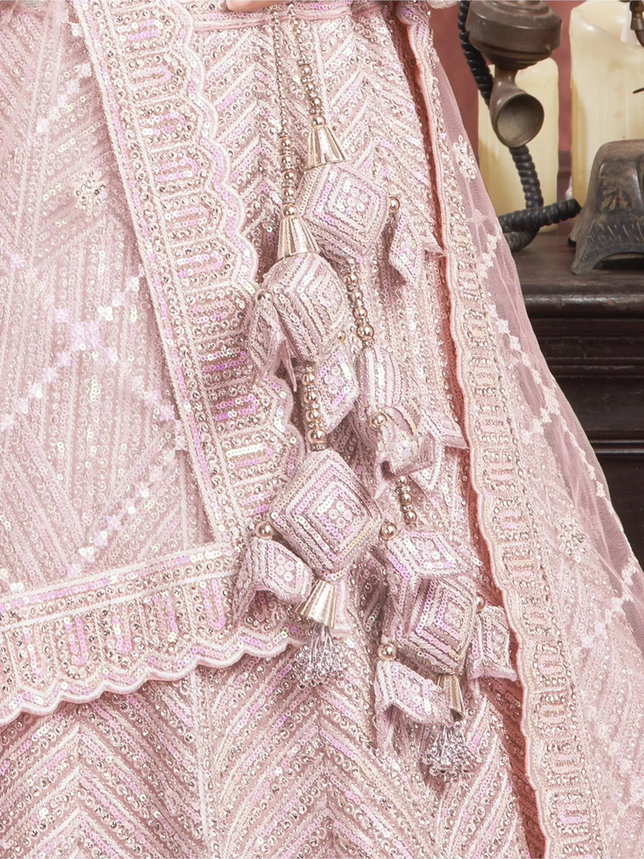 Pink sequined ethnic gown with tassels and intricate embroidery for festive occasions