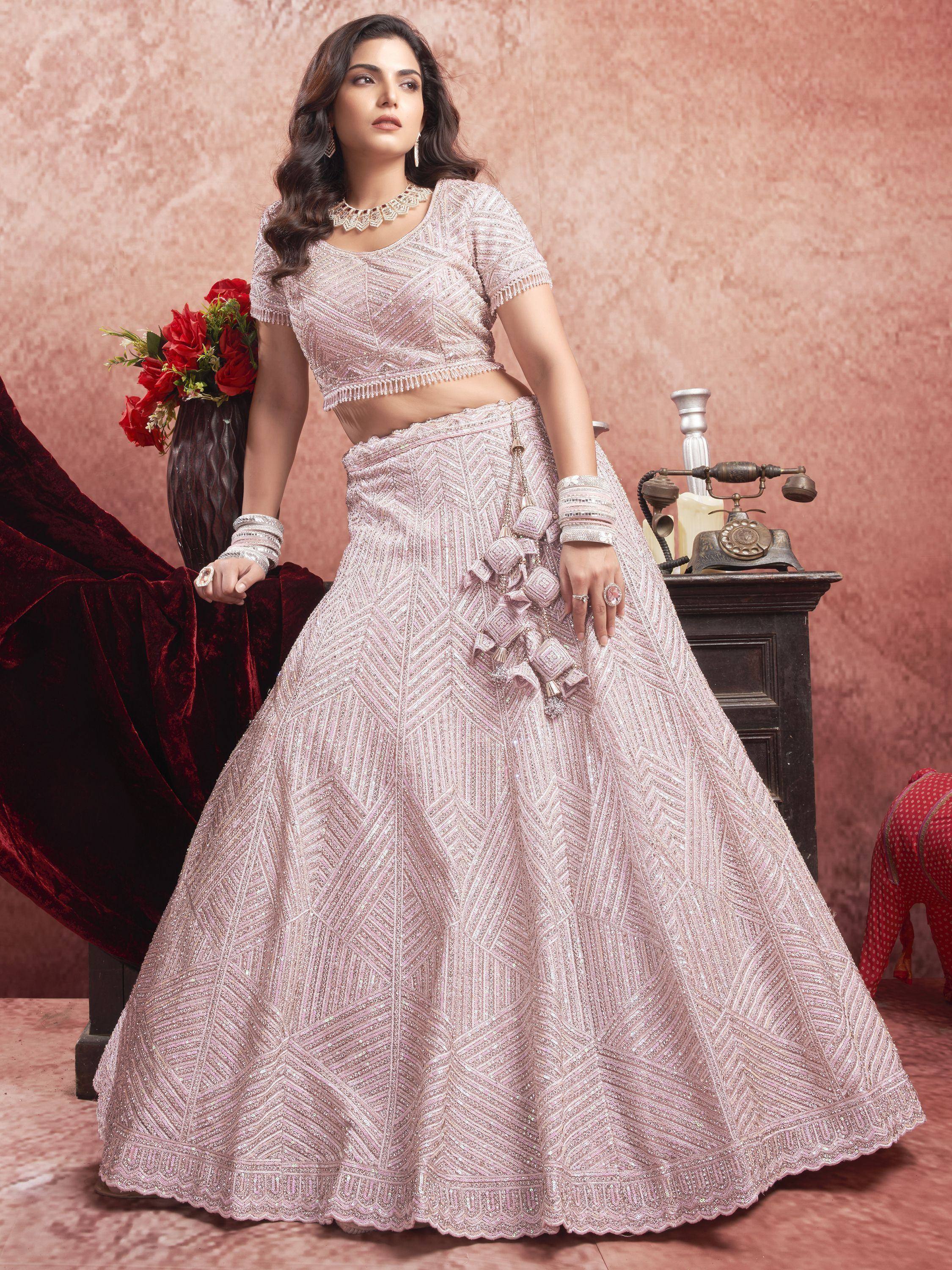Elegant pink designer lehenga choli with intricate embroidery, perfect for weddings and festive occasions.