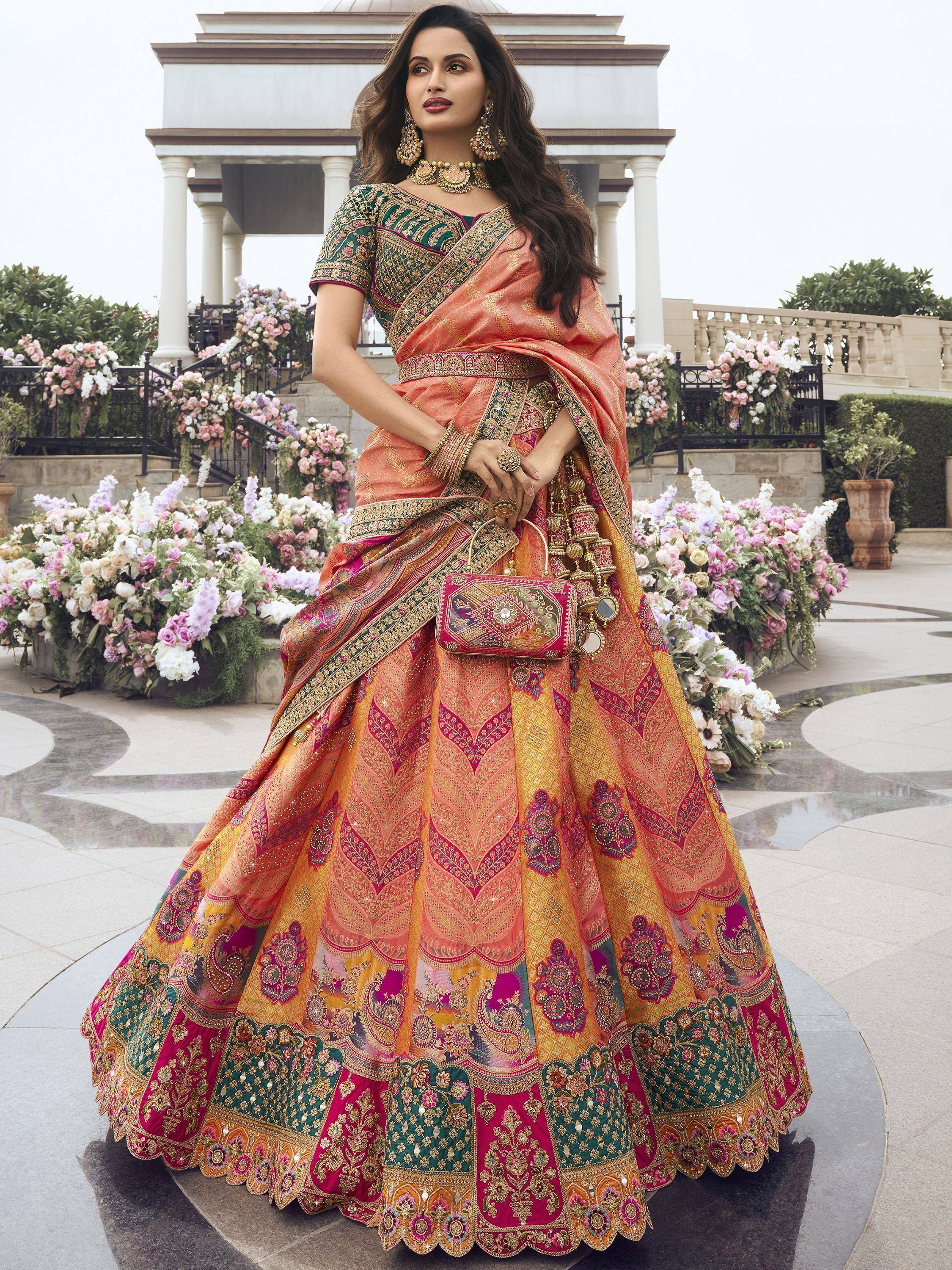 Woman in vibrant designer lehenga choli with intricate embroidery, perfect for Indian weddings and festive occasions.
