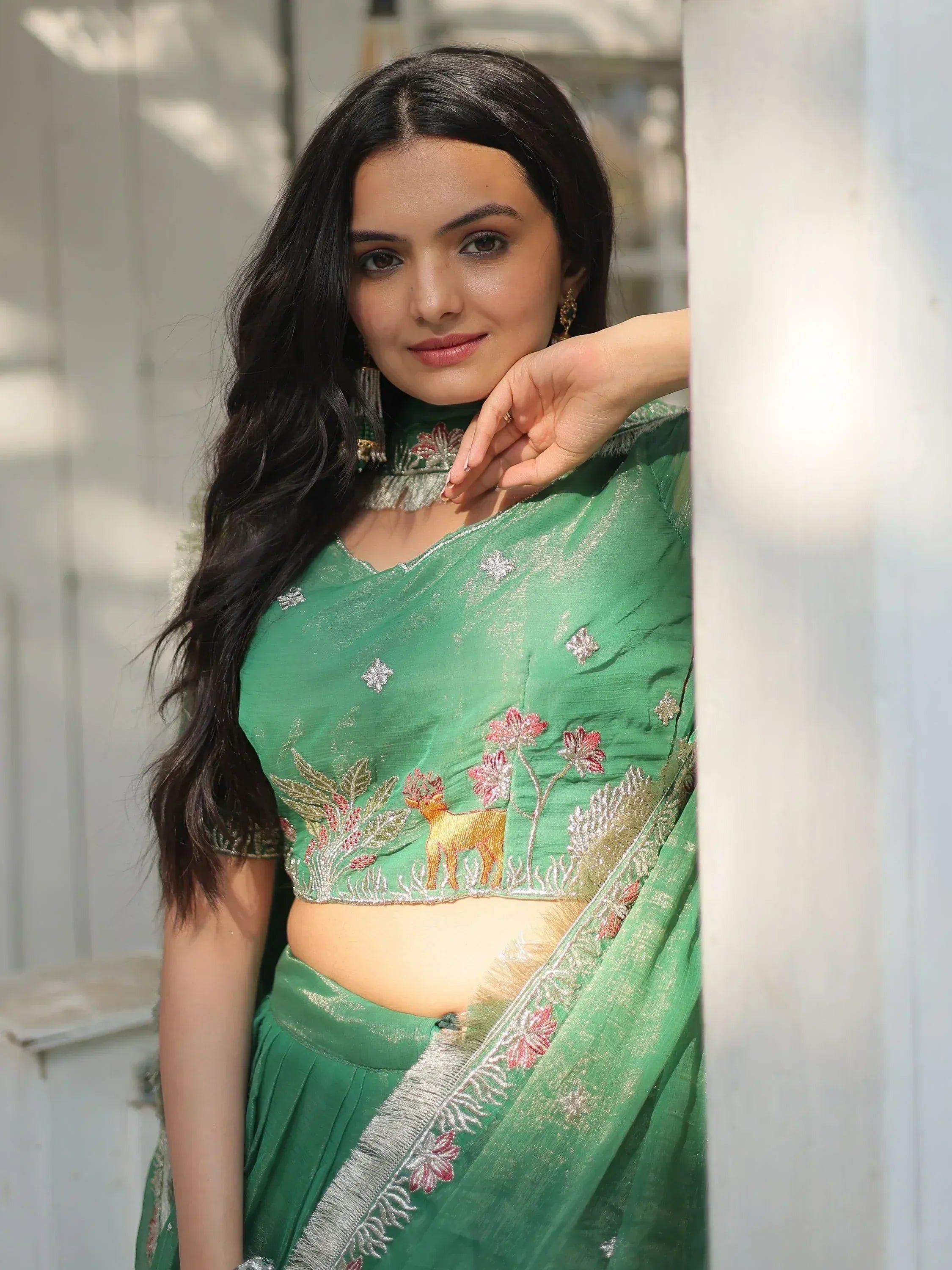Green embroidered lehenga choli with deer and floral motifs, perfect for Indian ethnic wear