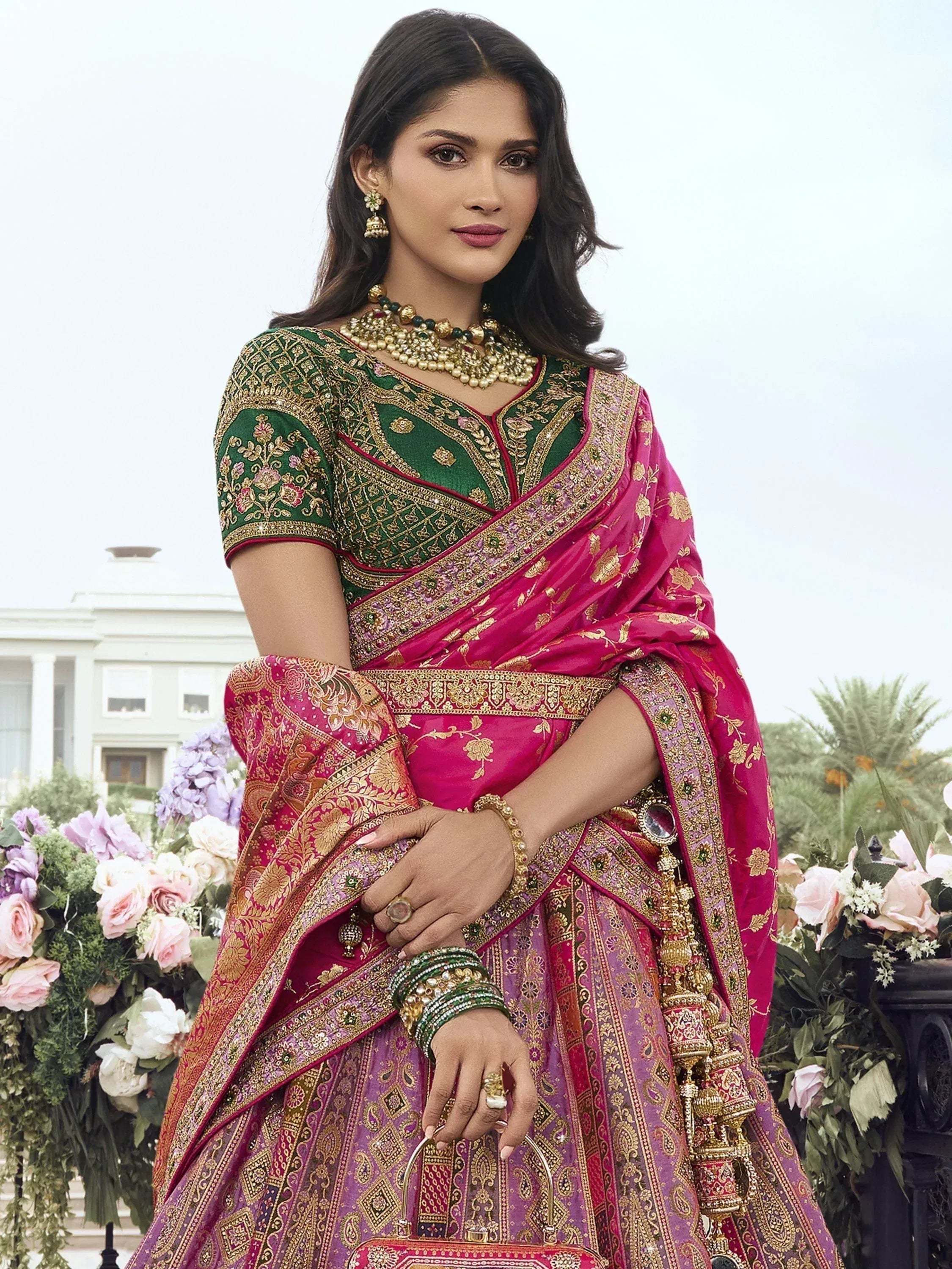 Elegant Indian bridal lehenga choli with pink and green embroidery, perfect for weddings and festive occasions.