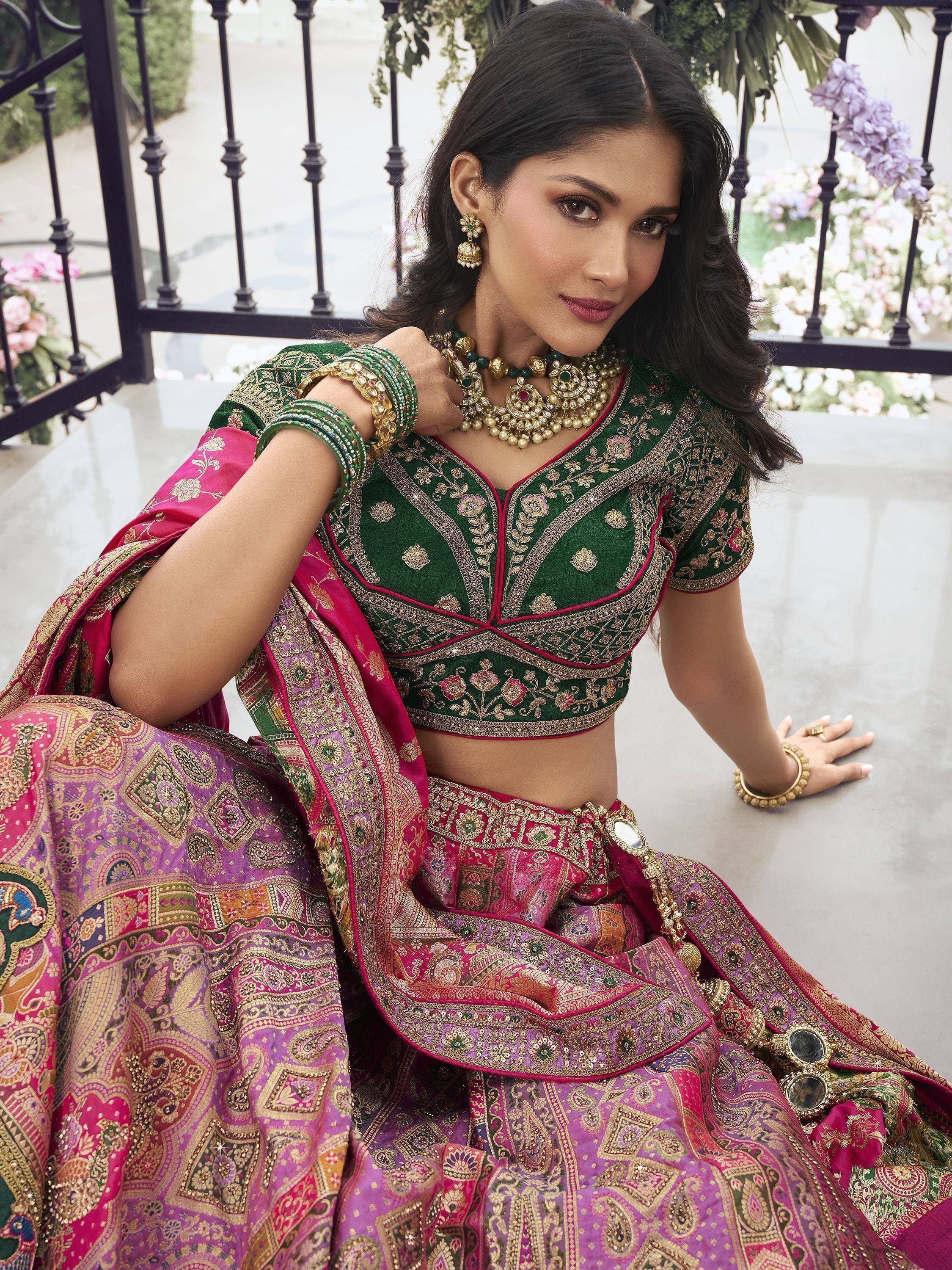 Elegant green and pink embroidered lehenga choli with gold detailing, perfect for Indian weddings and festive occasions.