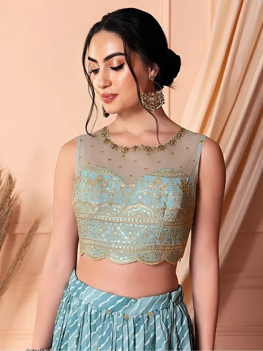 Light blue embroidered crop top with gold detailing, paired with matching pleated skirt, ideal for Indian ethnic wear