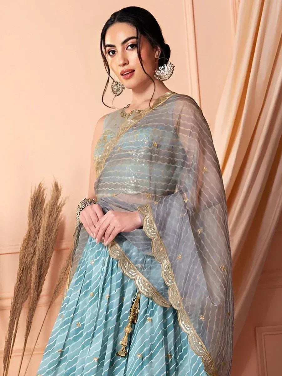Elegant light blue lehenga choli with gold embroidery and sheer dupatta, perfect for Indian ethnic occasions