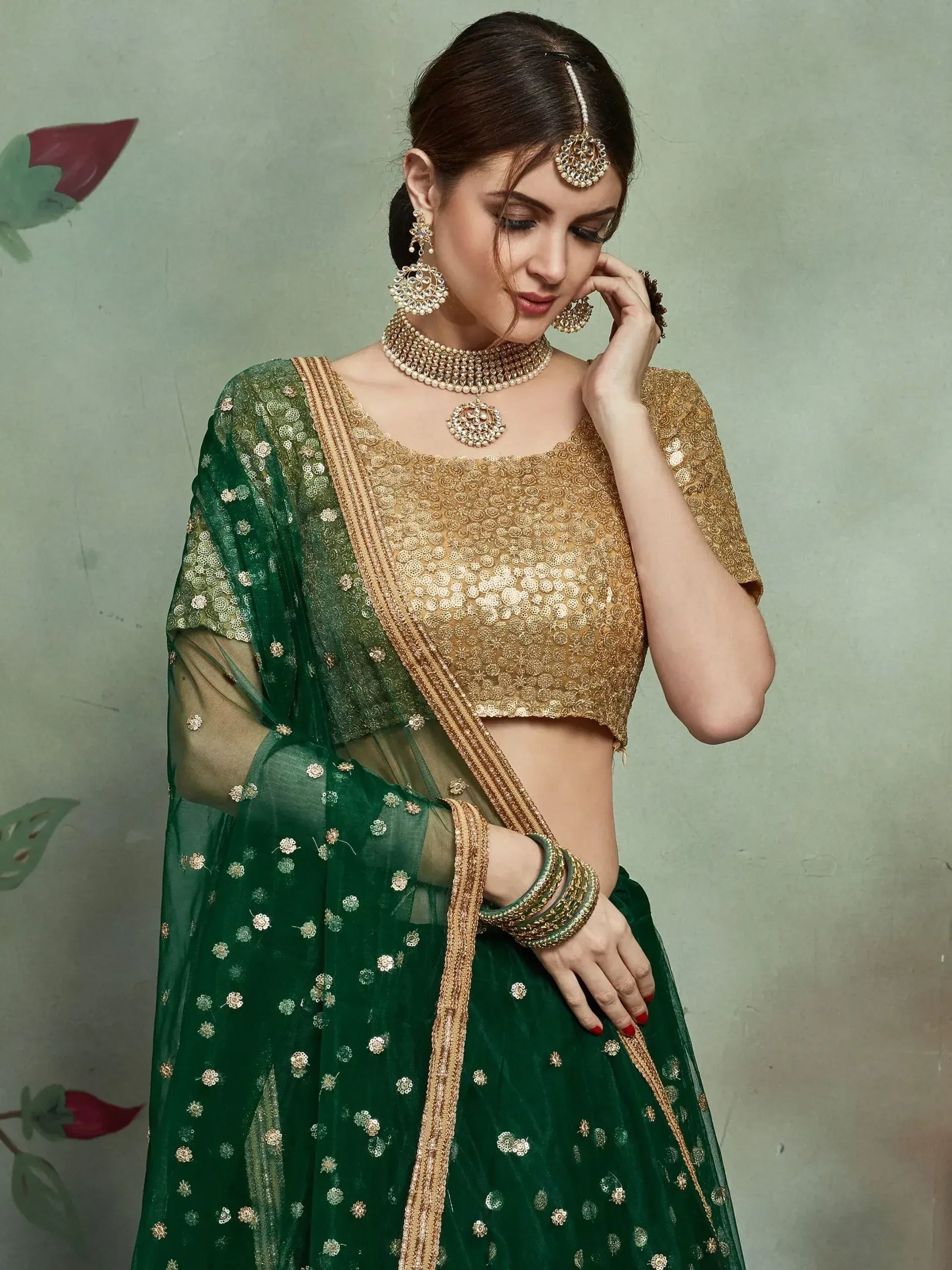 Emerald green lehenga choli with gold embroidery, perfect for Indian ethnic wear and festive occasions.