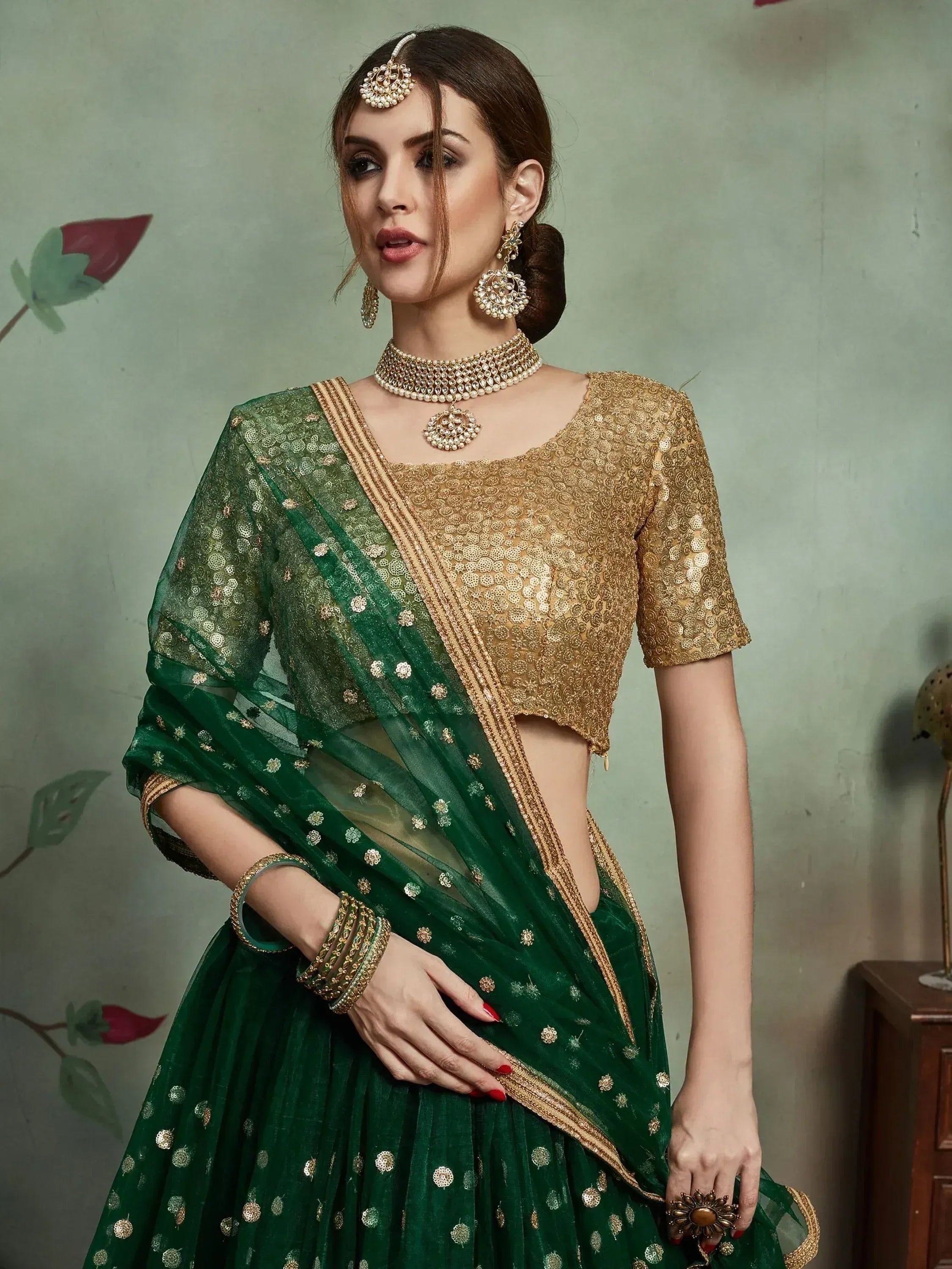 Emerald green lehenga choli with gold embroidery, perfect for Indian ethnic wear and festive occasions.